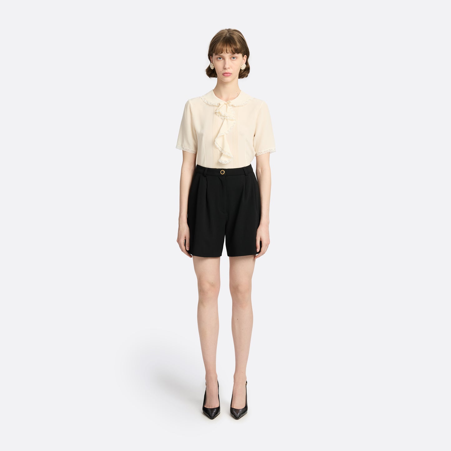 Cream silk crêpe de chine blouse with small collar, jabot and short sleeves all trimmed in lace and a back button closure.