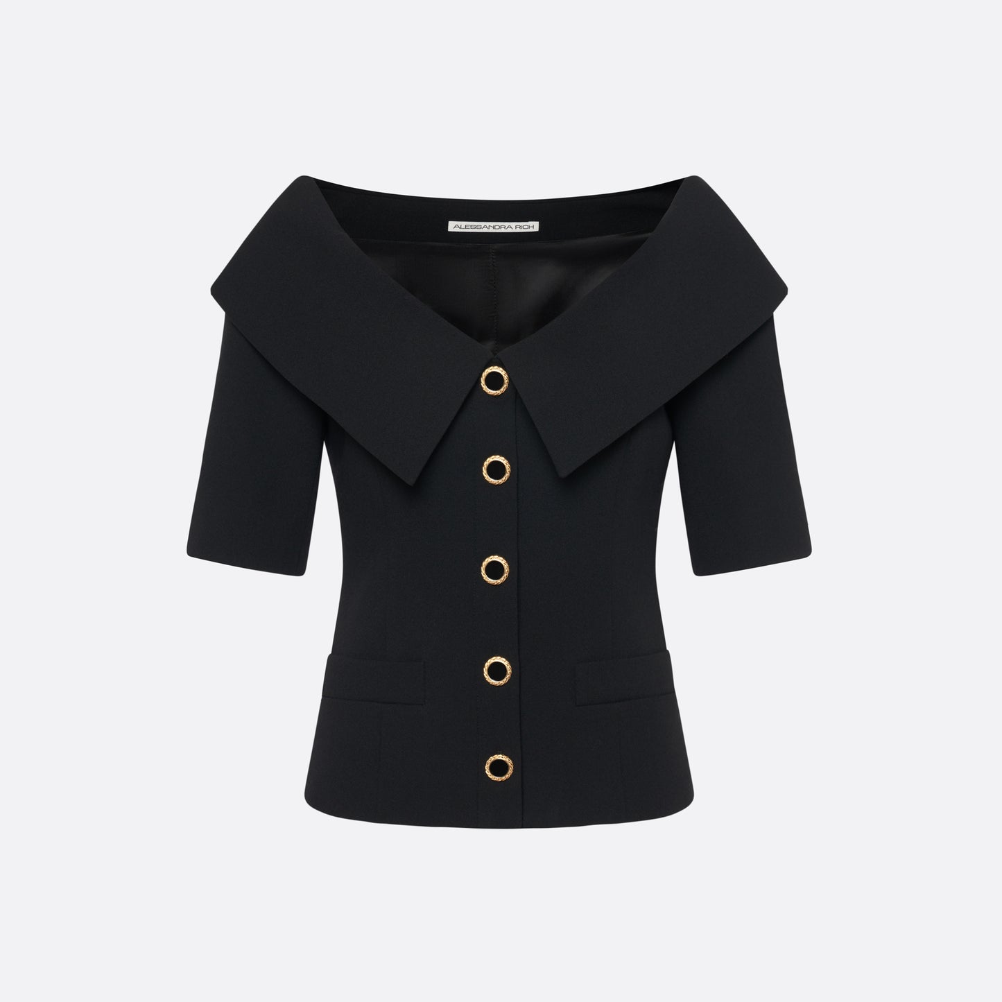 Black wool crêpe off-shoulder jacket with a wide folded neckline and short sleeves. Finished with black and gold-tone buttons and welt pockets.