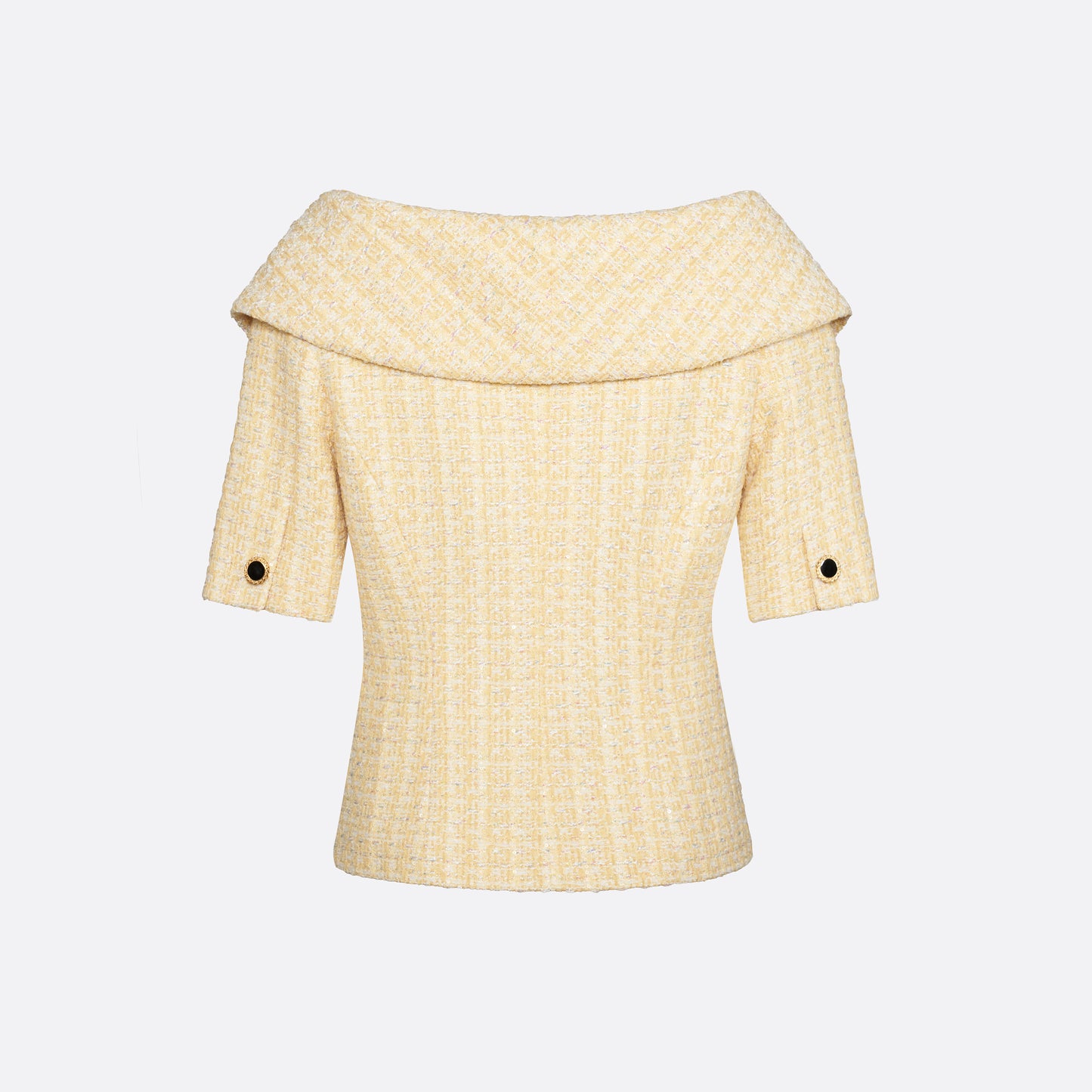 Pale yellow sequin tweed off-shoulder jacket with a wide folded neckline and short sleeves. Finished with black and gold-tone buttons and welt pockets.