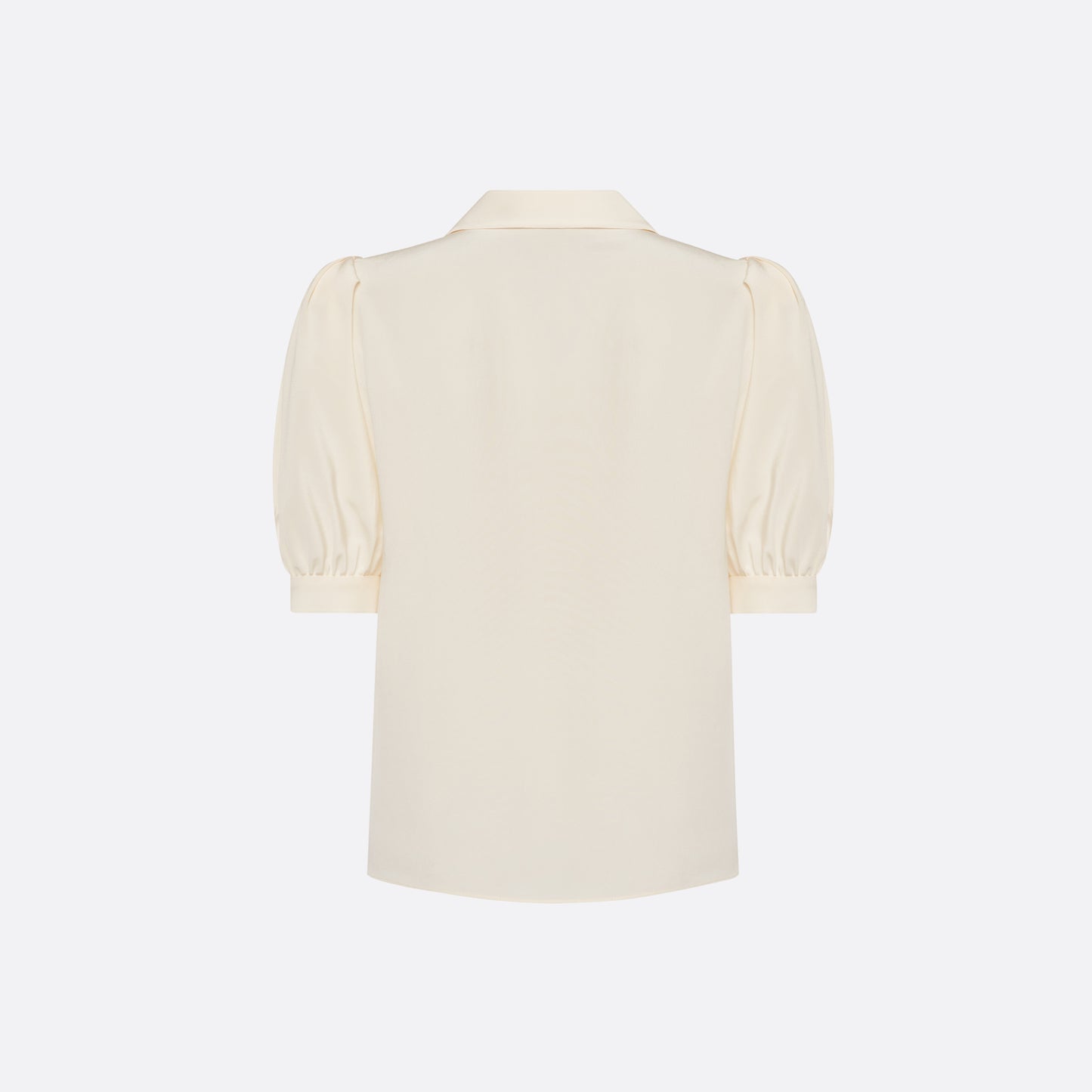 Cream silk crêpe de chine blouse with a short puff sleeves and a front button closure.
