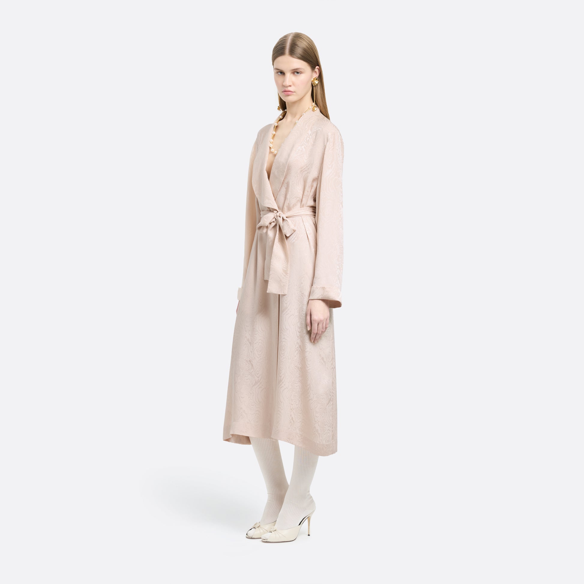Blush silk moiré robe cut to a fluid silhouette with a shawl collar and long sleeves. Finished with a self-tie belt at the waist.