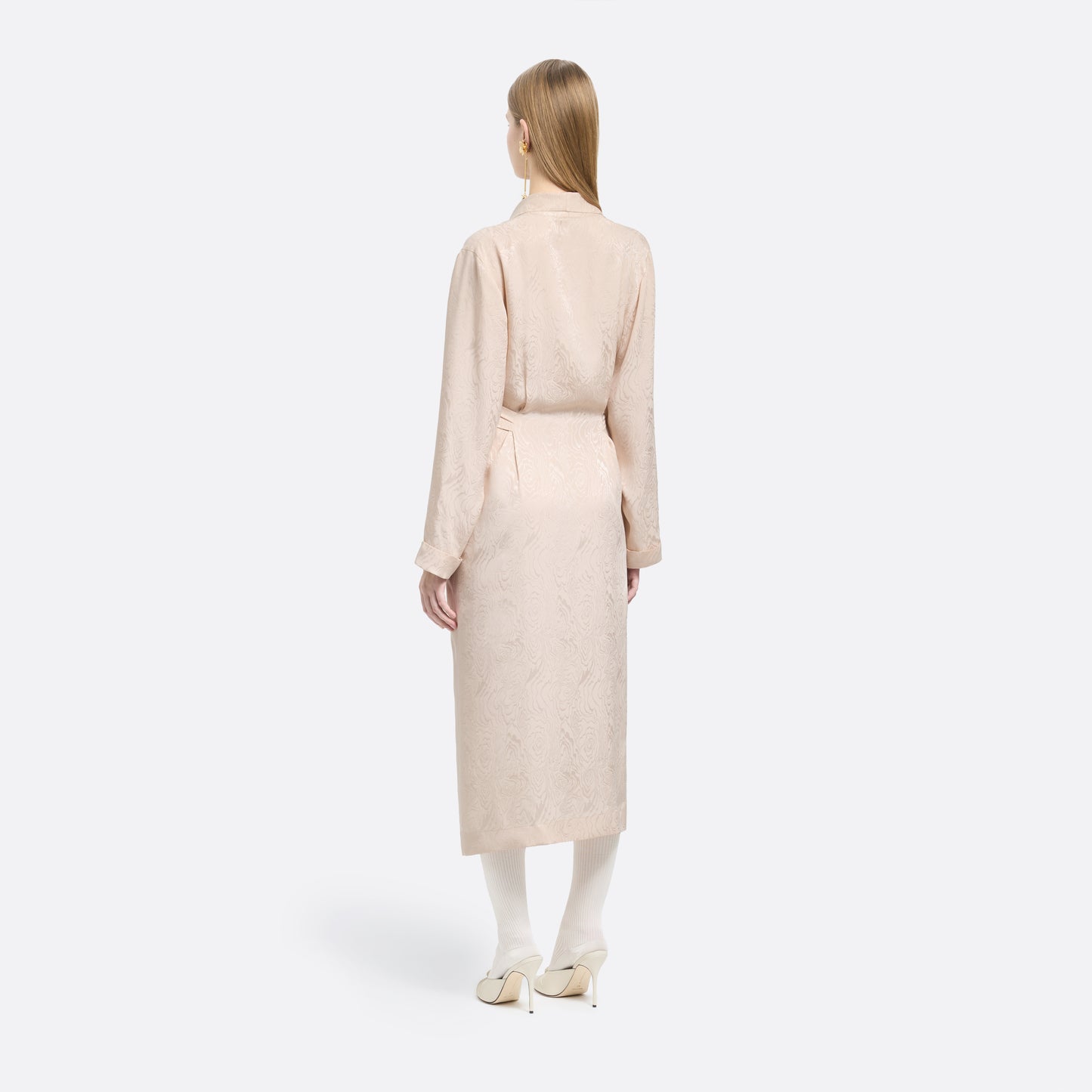 Blush silk moiré robe cut to a fluid silhouette with a shawl collar and long sleeves. Finished with a self-tie belt at the waist.