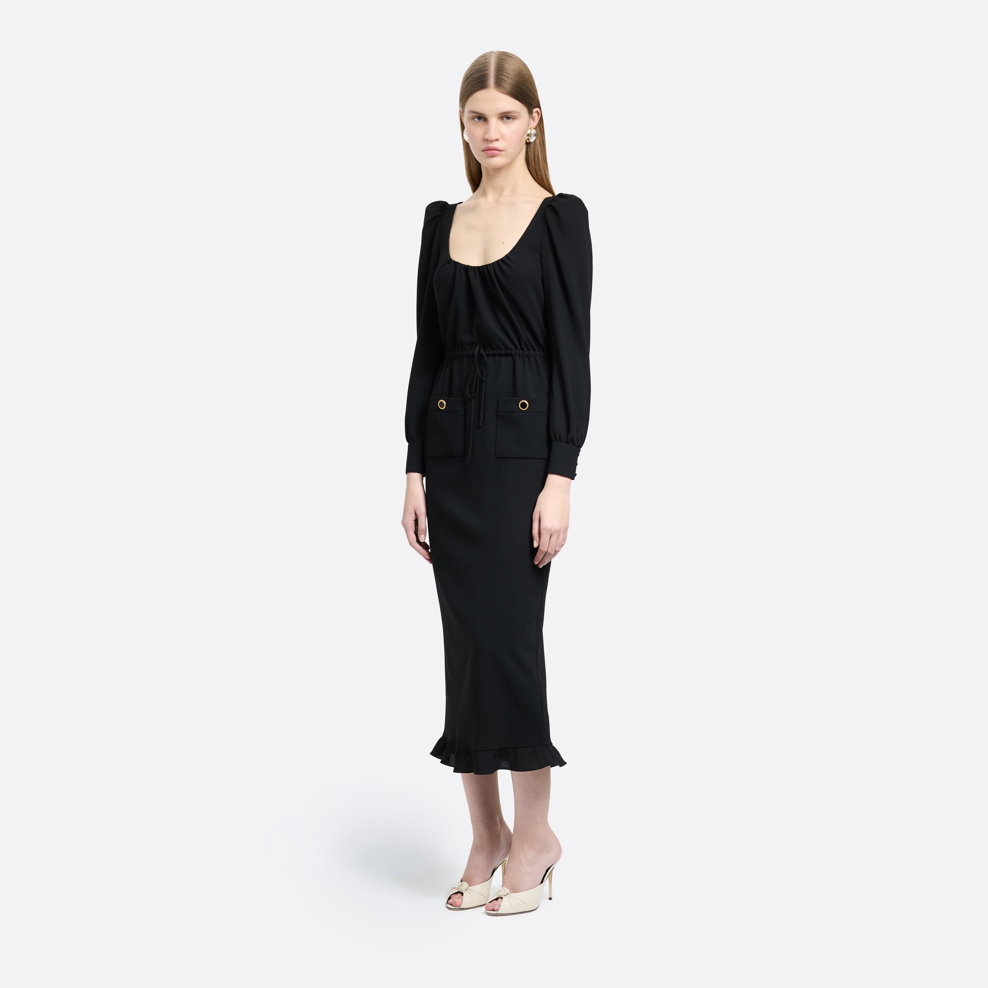 Black light wool crêpe midi dress with a scoop neckline, long sleeves and a drawstring waist. Finished with patch pockets and black and gold-tone buttons.