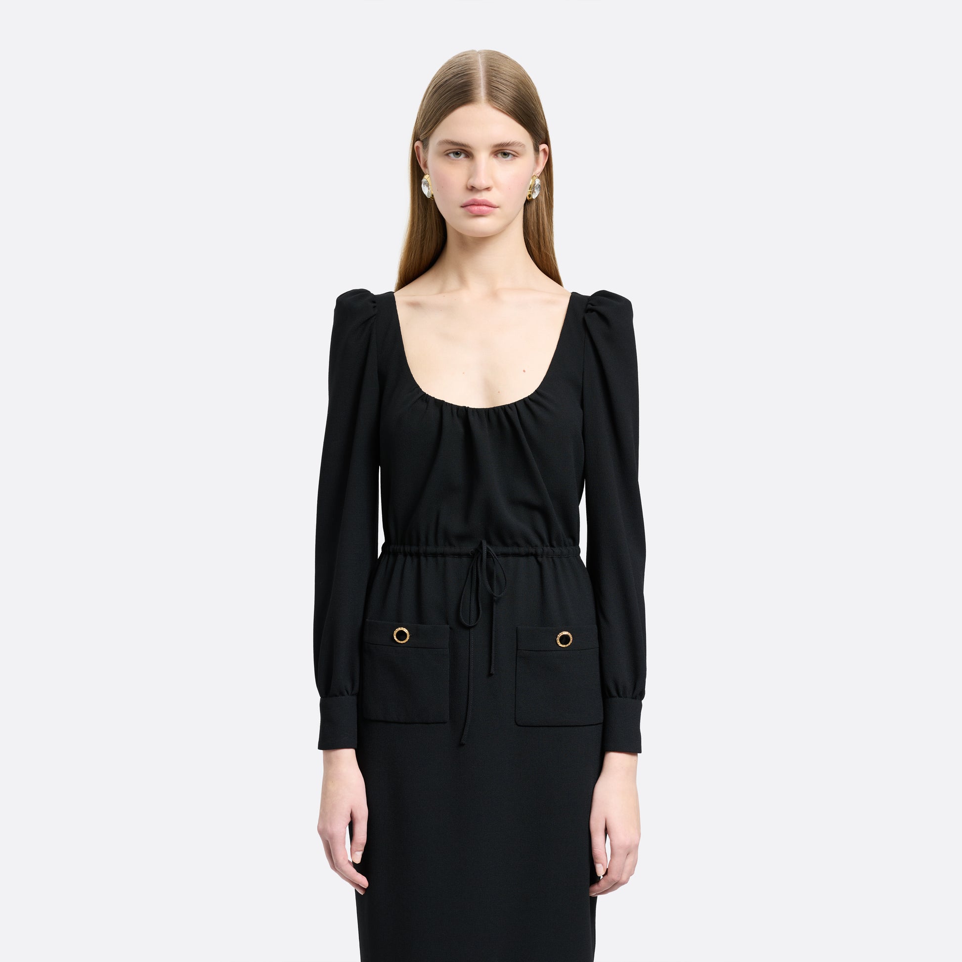 Black light wool crêpe midi dress with a scoop neckline, long sleeves and a drawstring waist. Finished with patch pockets and black and gold-tone buttons.