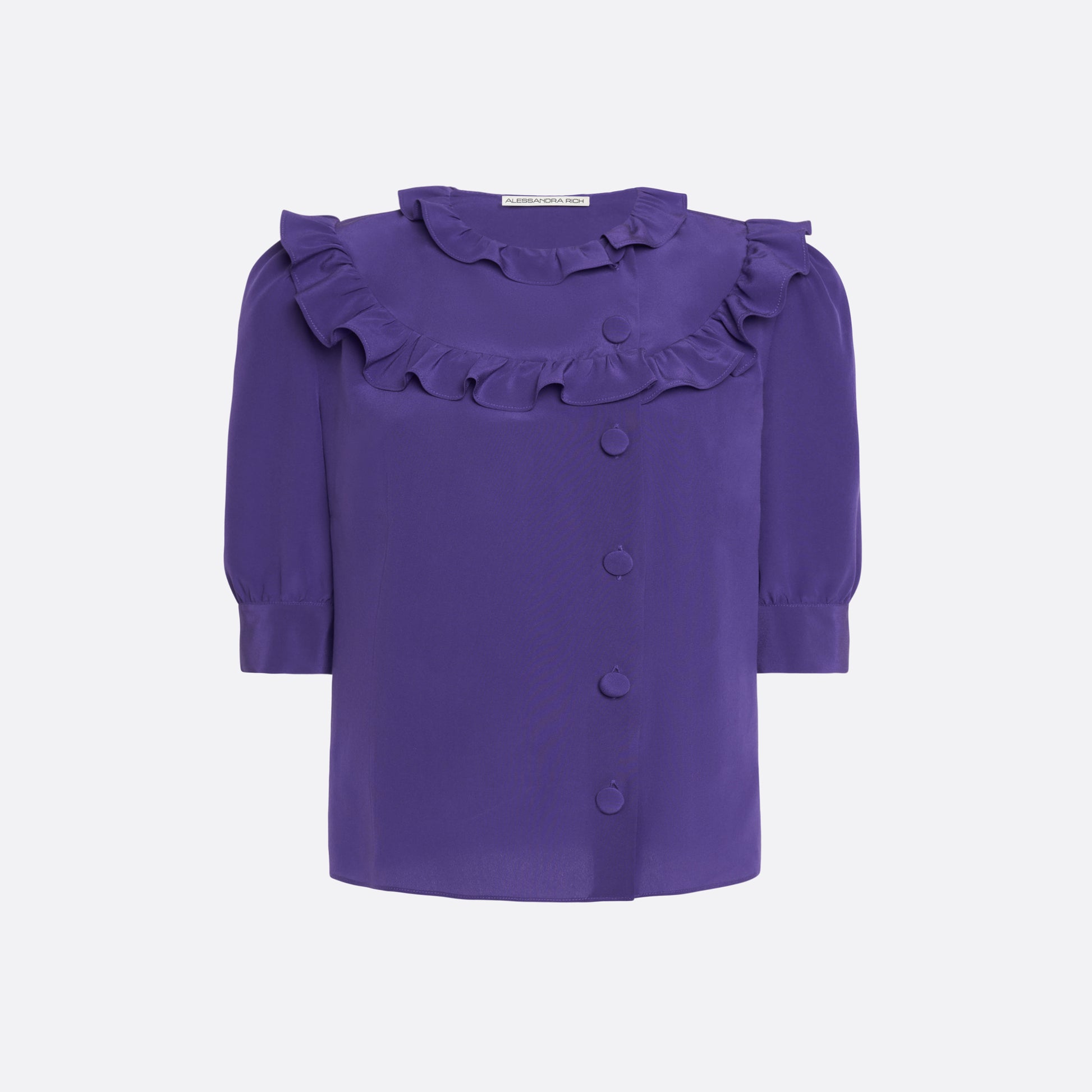 Purple silk crêpe de chine blouse with ruffle trims, short puff sleeves and a side button closure.

Look 7 – Fall Winter 2026 Lookbook.