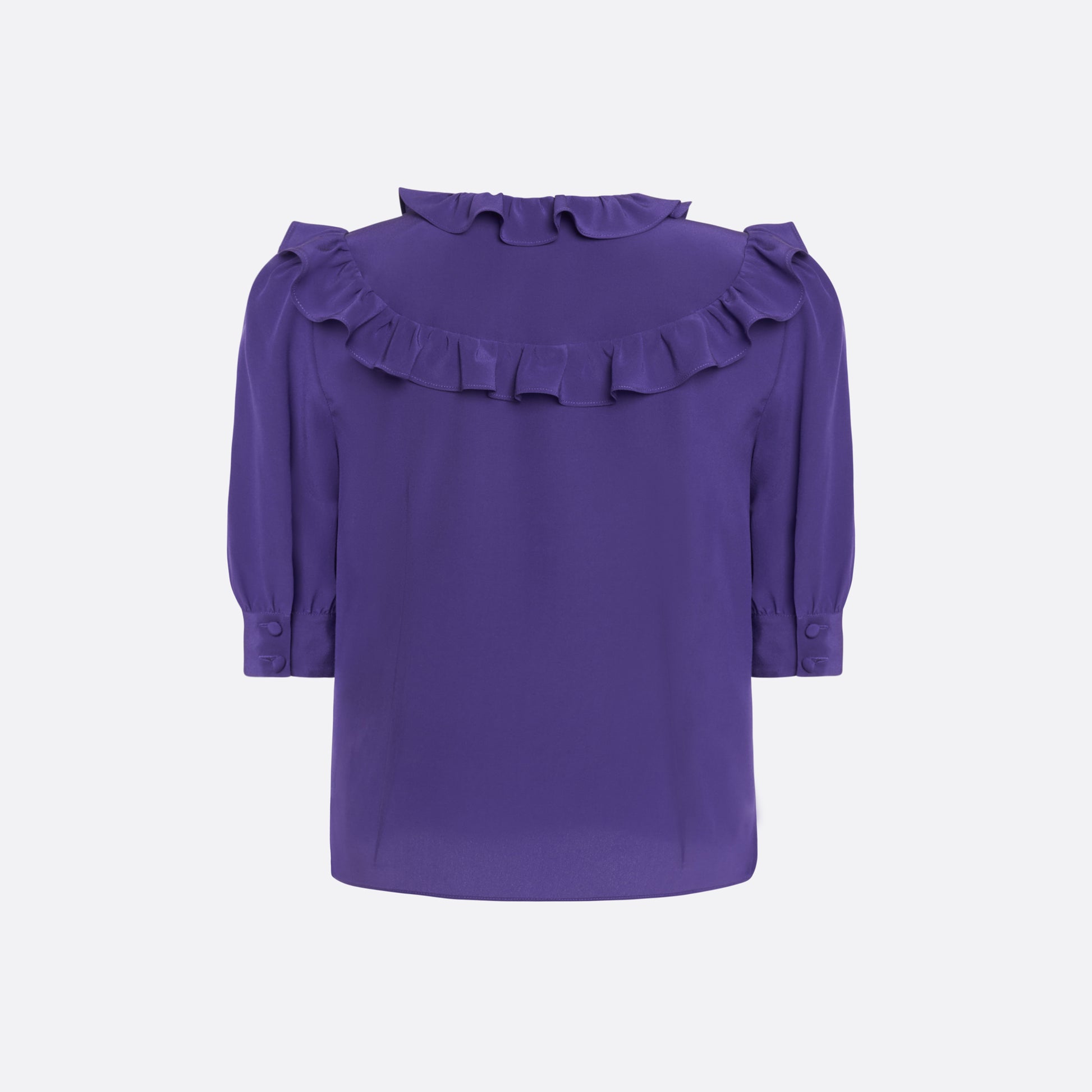 Purple silk crêpe de chine blouse with ruffle trims, short puff sleeves and a side button closure.

Look 7 – Fall Winter 2026 Lookbook.