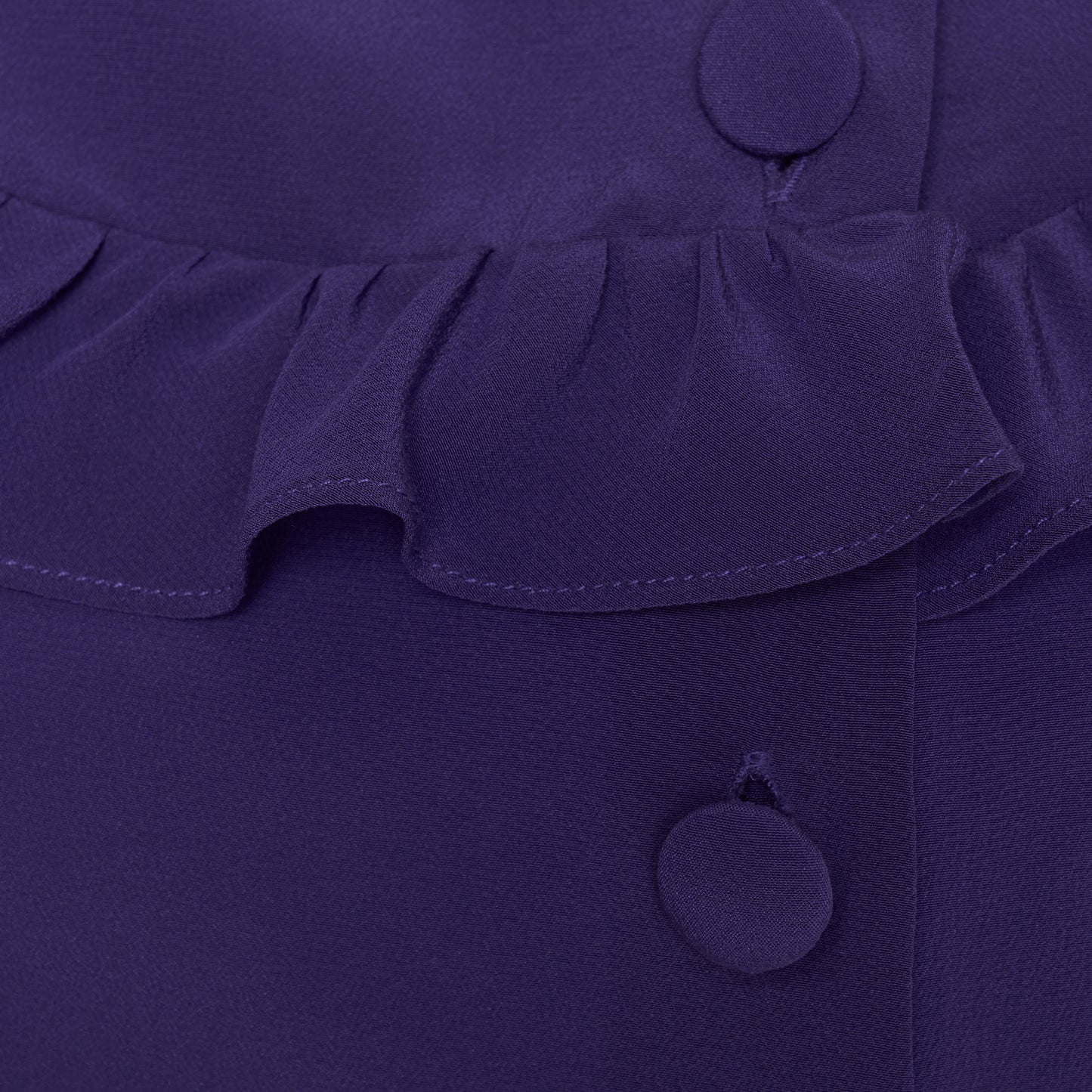 Purple silk crêpe de chine blouse with ruffle trims, short puff sleeves and a side button closure.

Look 7 – Fall Winter 2026 Lookbook.