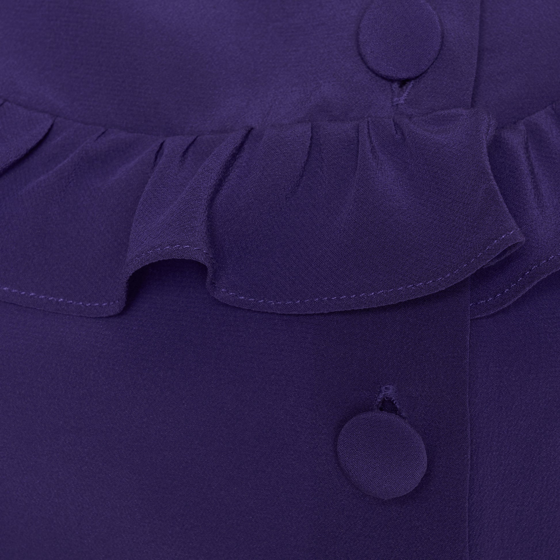 Purple silk crêpe de chine blouse with ruffle trims, short puff sleeves and a side button closure.

Look 7 – Fall Winter 2026 Lookbook.