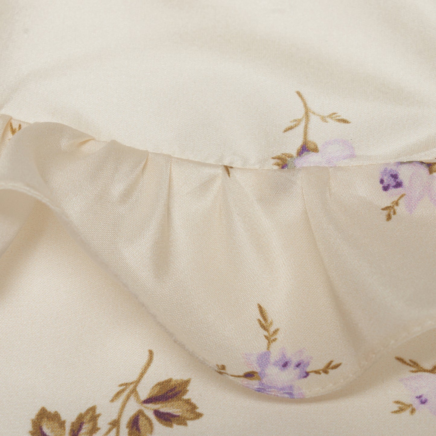 Floral-print white silk taffeta blouse with ruffle trims, short puff sleeves and a side button closure.