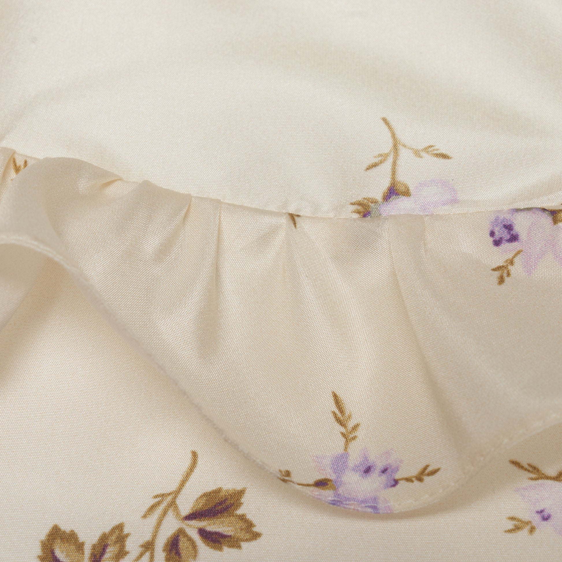 Floral-print white silk taffeta blouse with ruffle trims, short puff sleeves and a side button closure.