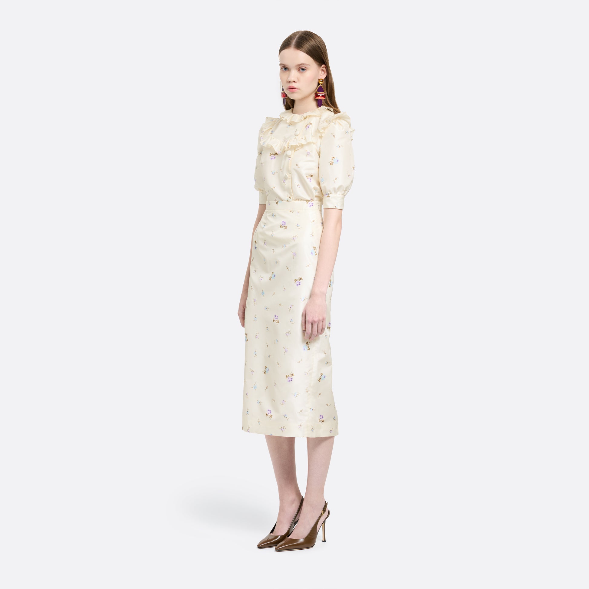 Floral-print white silk taffeta blouse with ruffle trims, short puff sleeves and a side button closure.
