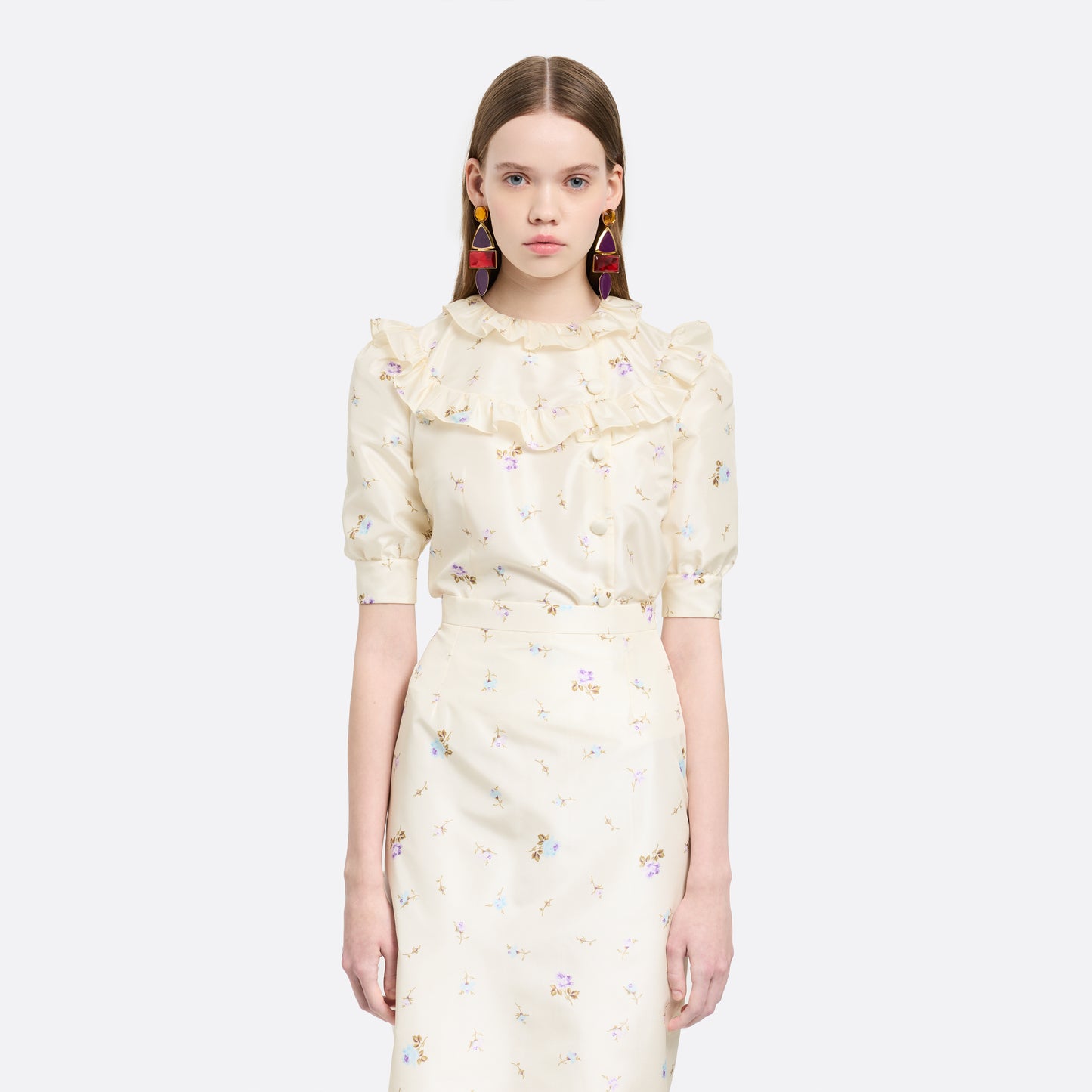 Floral-print white silk taffeta blouse with ruffle trims, short puff sleeves and a side button closure.