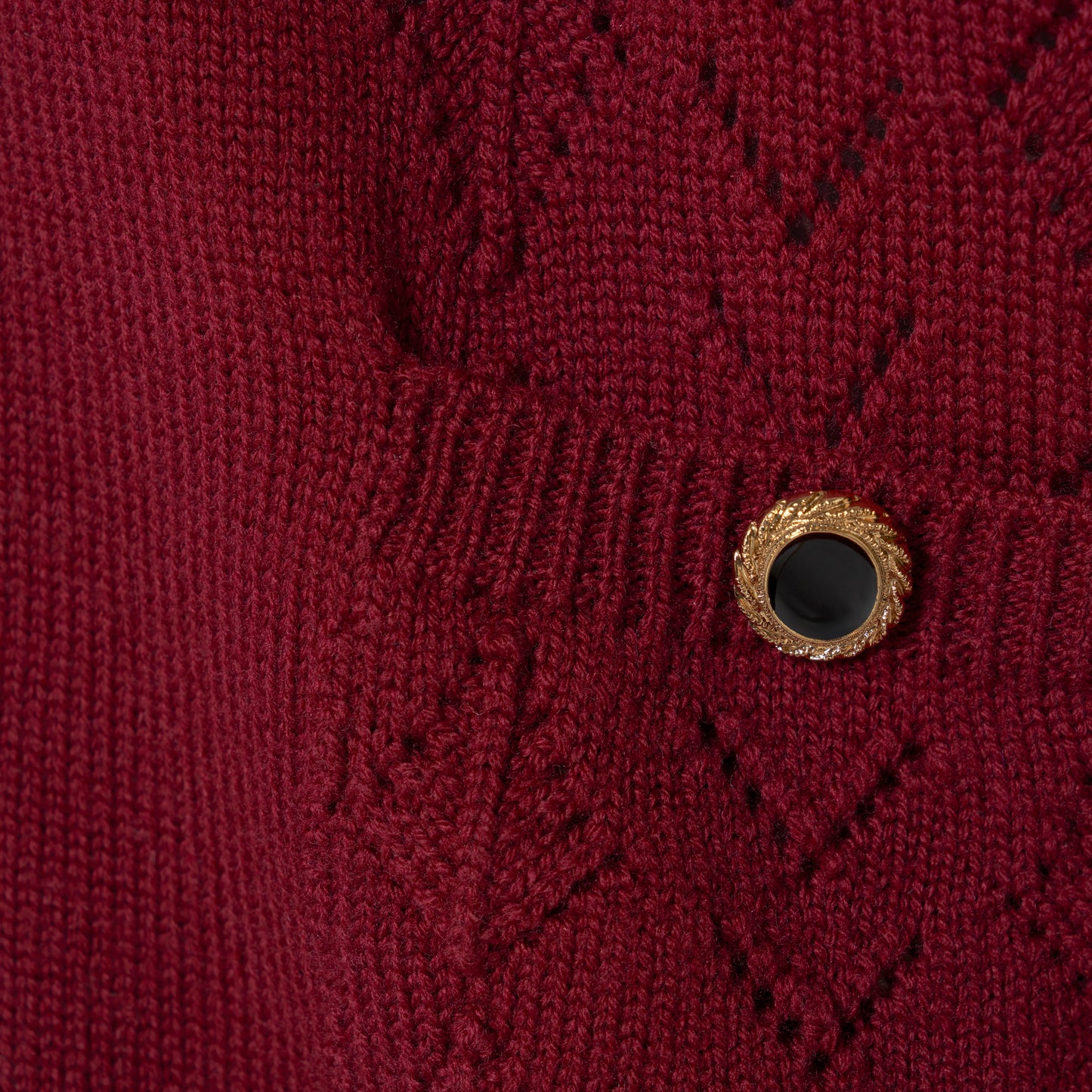 Bordeaux merino wool lace-knit cardigan cut to a relaxed silhouette with a V-neckline. Finished with patch pockets and black and gold-tone buttons.