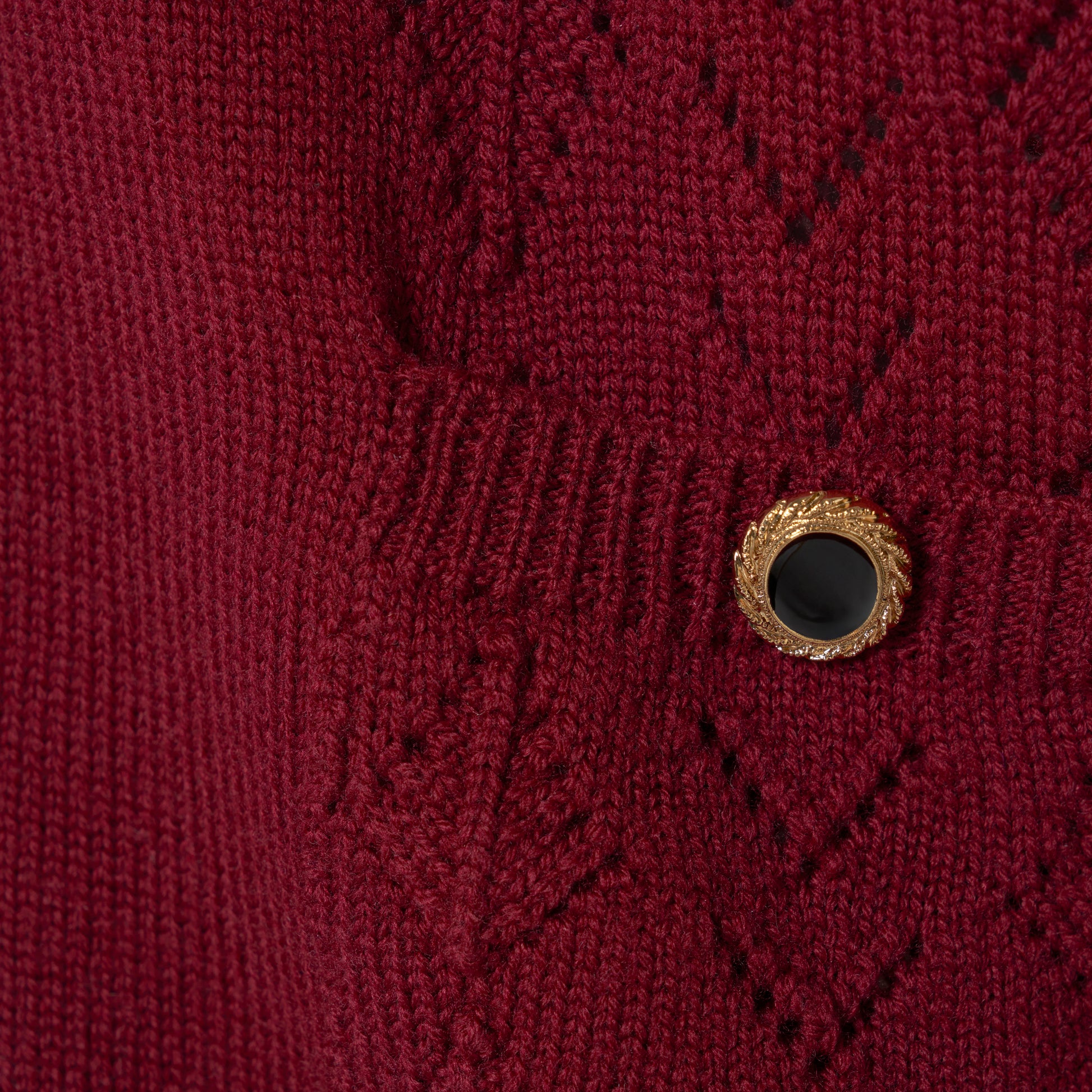 Bordeaux merino wool lace-knit cardigan cut to a relaxed silhouette with a V-neckline. Finished with patch pockets and black and gold-tone buttons.