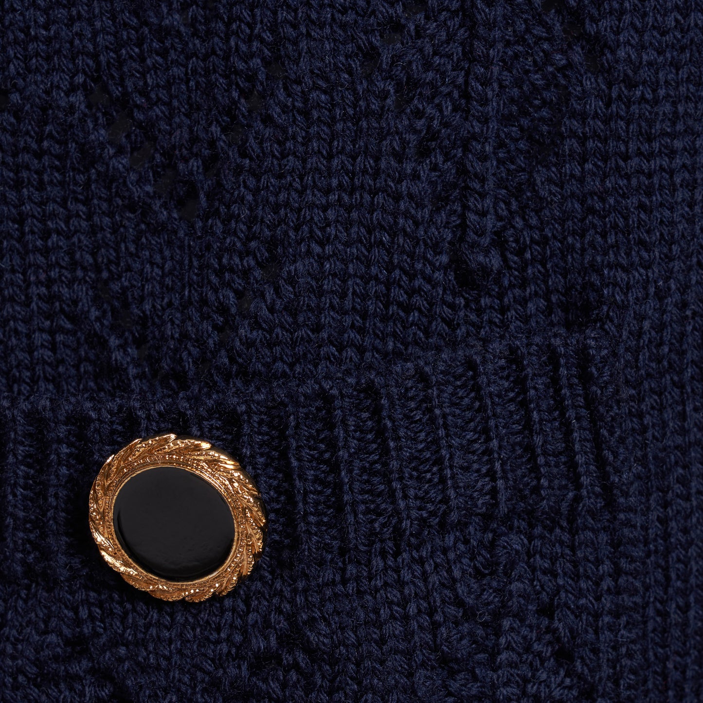 Navy merino wool lace-knit cardigan cut to a relaxed silhouette with a V-neckline. Finished with patch pockets and black and gold-tone buttons.
