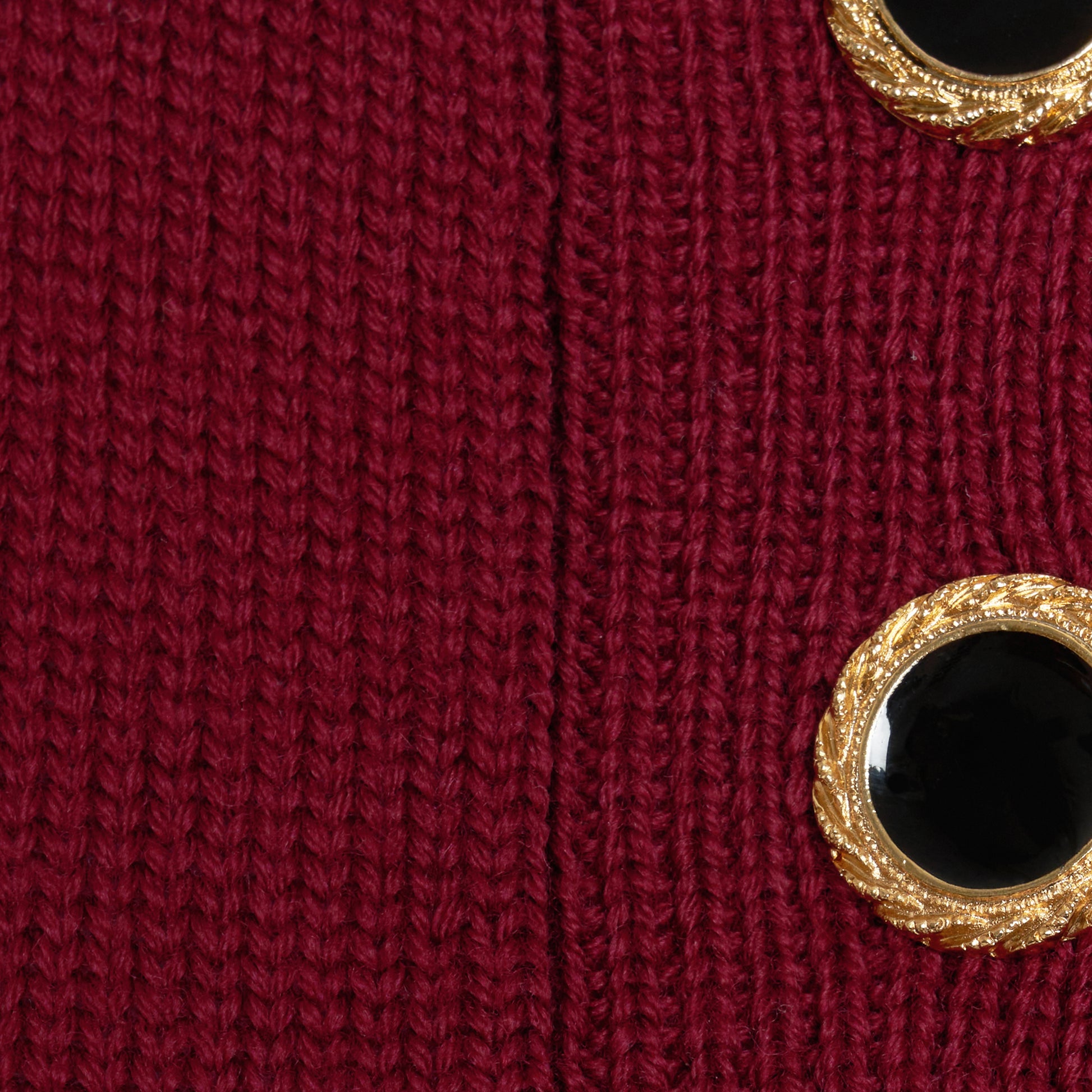 Bordeaux merino wool lace-knit polo cut to a fitted silhouette with short puff sleeves and black and gold-tone buttons.