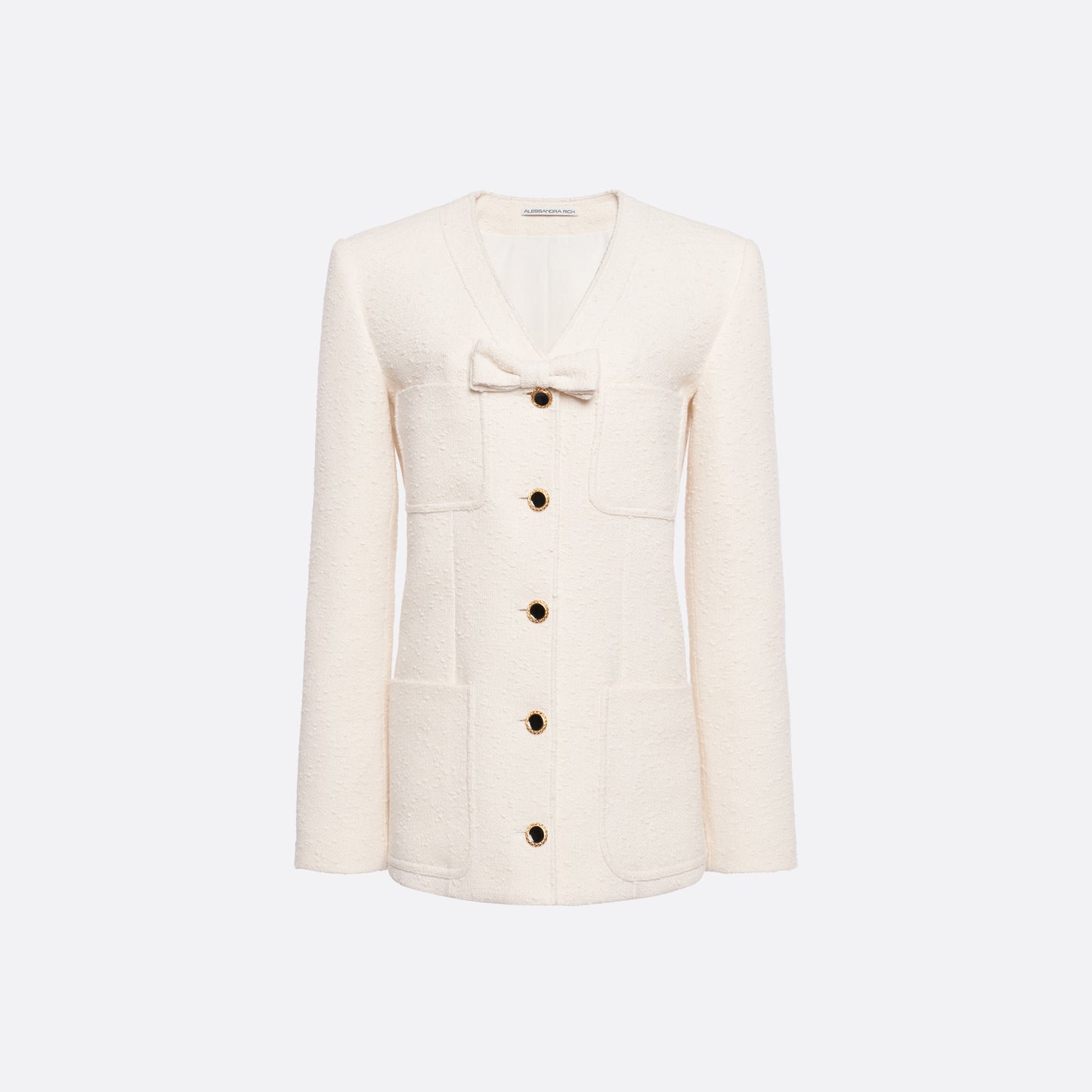 Ivory tweed bouclé jacket cut to a longline silhouette with a V-neckline and patch pockets. Finished with black and gold-tone buttons and a bow detail.