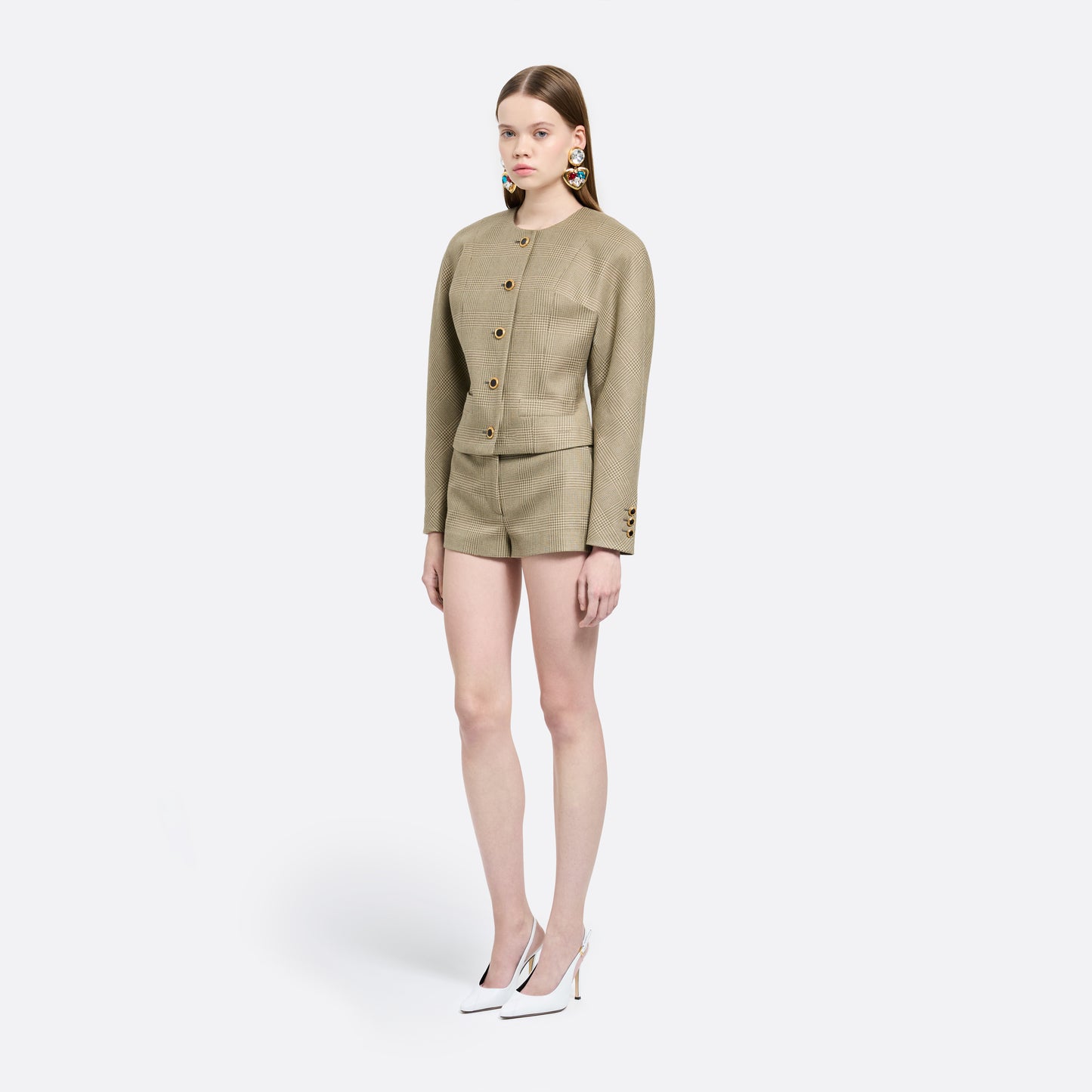 Green and beige Prince of Wales wool jacket cut in a cropped silhouette with a fitted waist. Finished with black and gold-tone buttons and welt pockets.