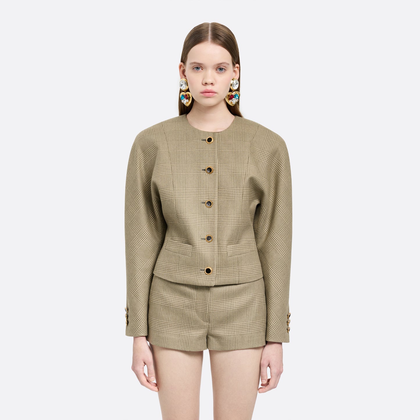 Green and beige Prince of Wales wool jacket cut in a cropped silhouette with a fitted waist. Finished with black and gold-tone buttons and welt pockets.