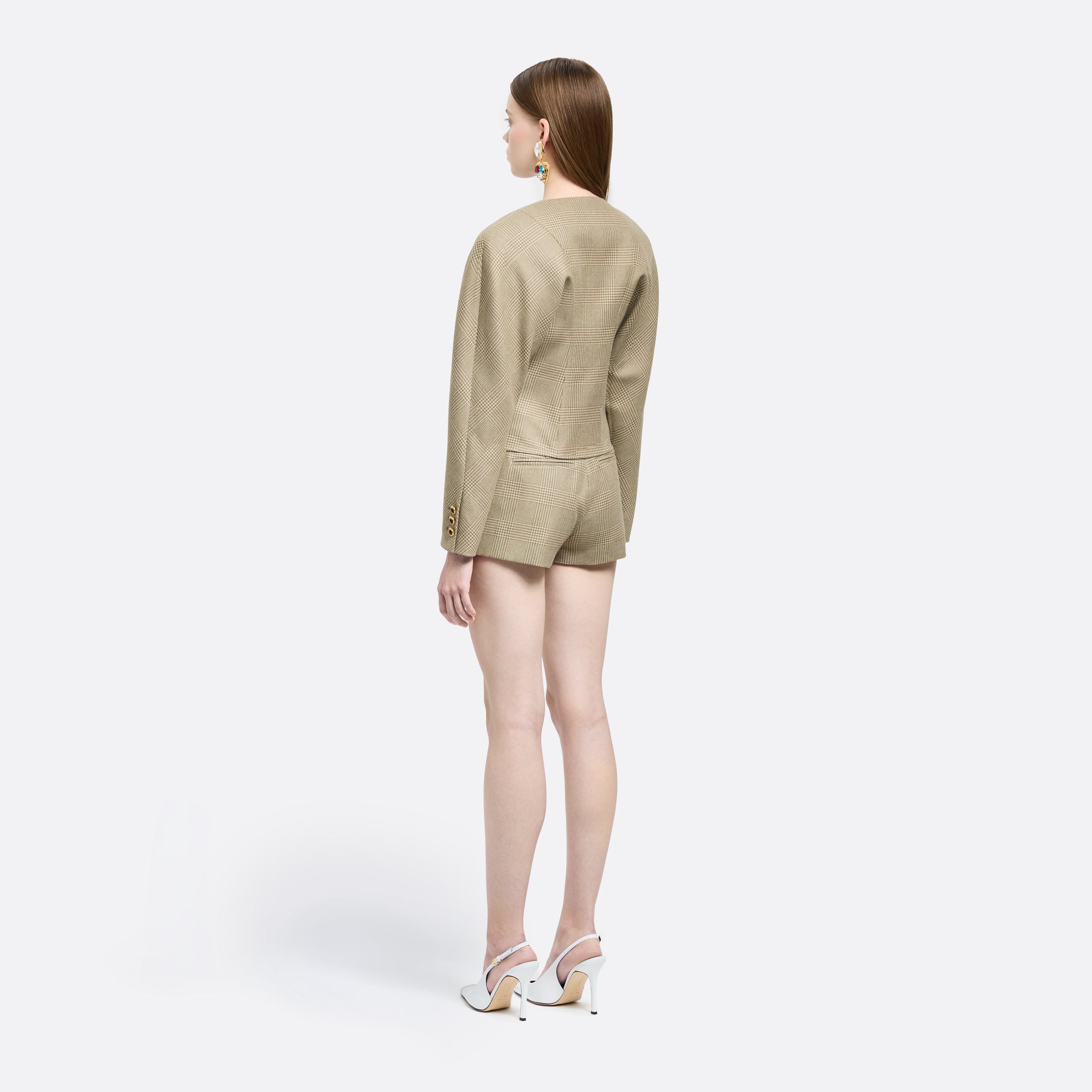 Green and beige Prince of Wales wool jacket cut in a cropped silhouette with a fitted waist. Finished with black and gold-tone buttons and welt pockets.