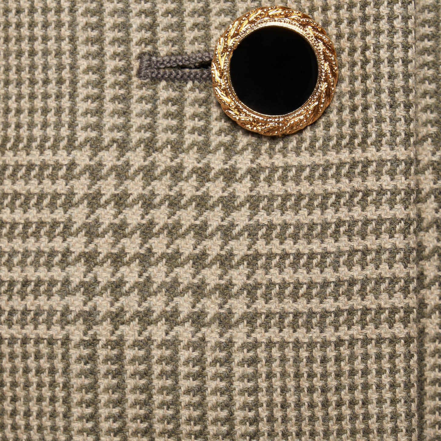 Green and beige Prince of Wales wool jacket cut in a cropped silhouette with a fitted waist. Finished with black and gold-tone buttons and welt pockets.