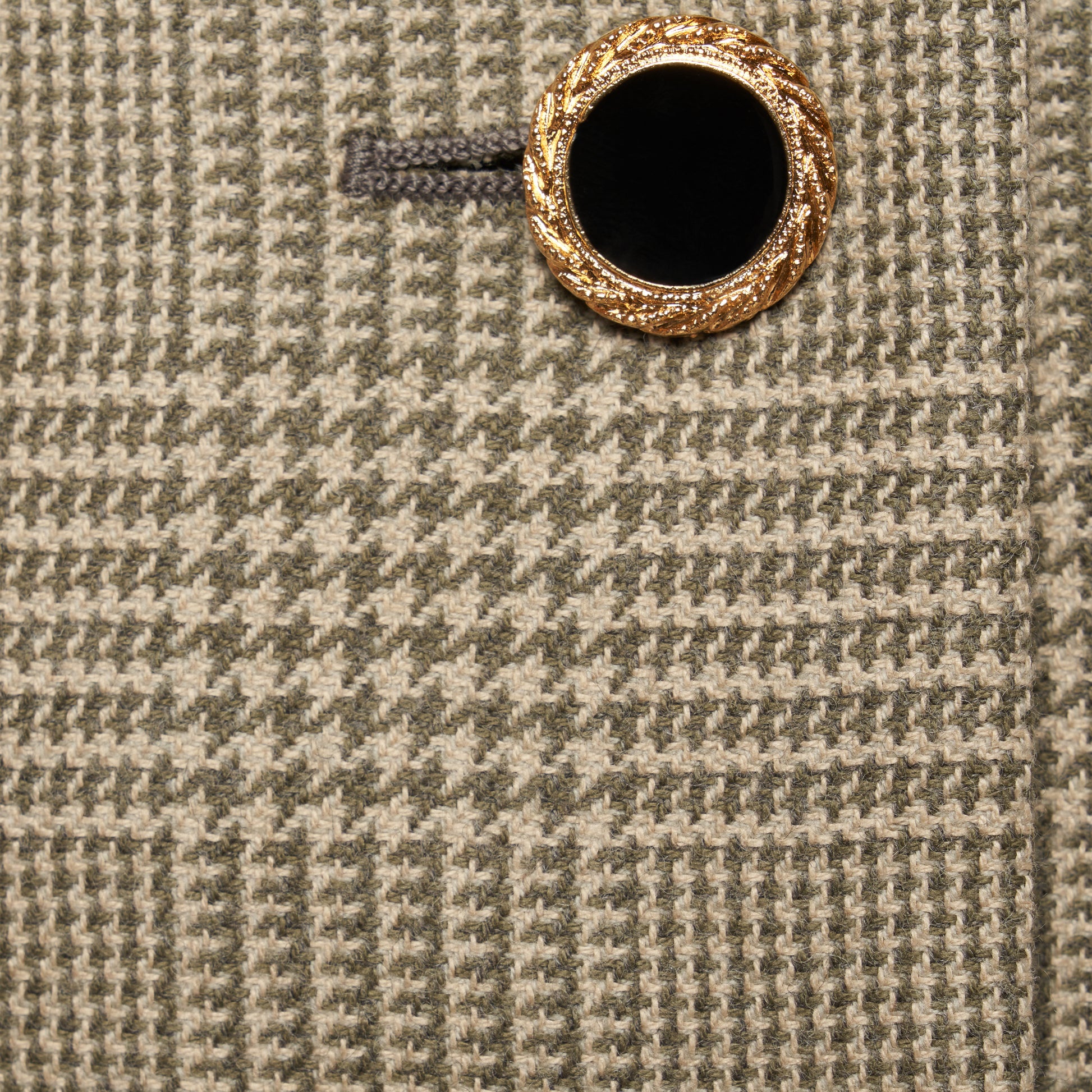Green and beige Prince of Wales wool jacket cut in a cropped silhouette with a fitted waist. Finished with black and gold-tone buttons and welt pockets.
