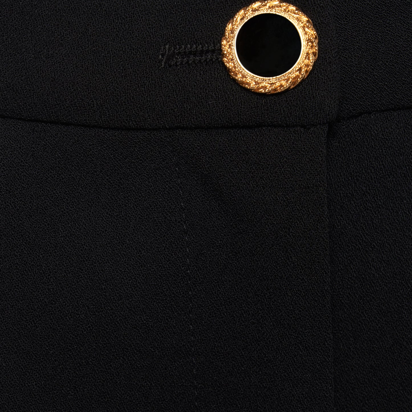 Black wool crêpe bermuda shorts tailored with a high waist and pleats. Finished with pockets and a black and gold-tone button.
