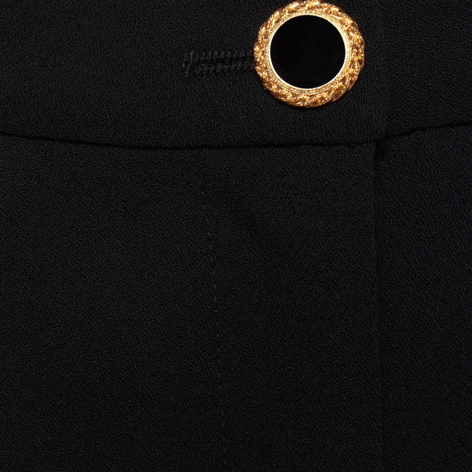 Black wool crêpe bermuda shorts tailored with a high waist and pleats. Finished with pockets and a black and gold-tone button.