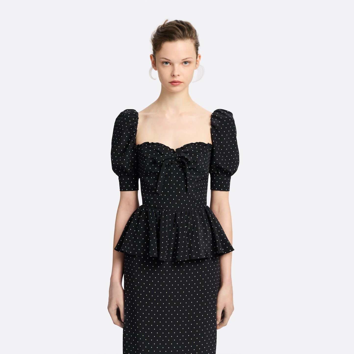 Ivory diamond print on black silk crêpe de chine midi dress with puff sleeves and pencil skirt, featuring a peplum waist and a bow.