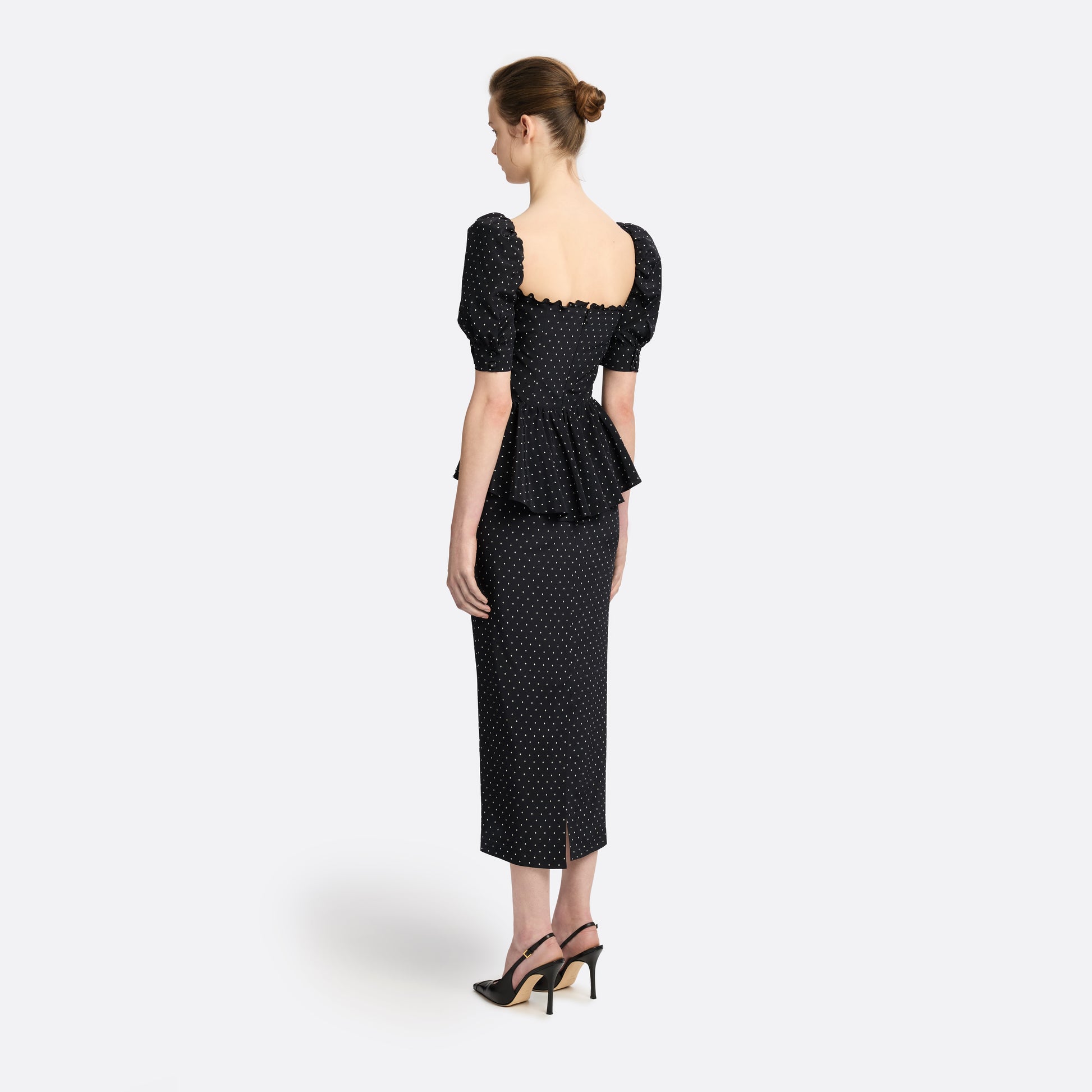 Ivory diamond print on black silk crêpe de chine midi dress with puff sleeves and pencil skirt, featuring a peplum waist and a bow.