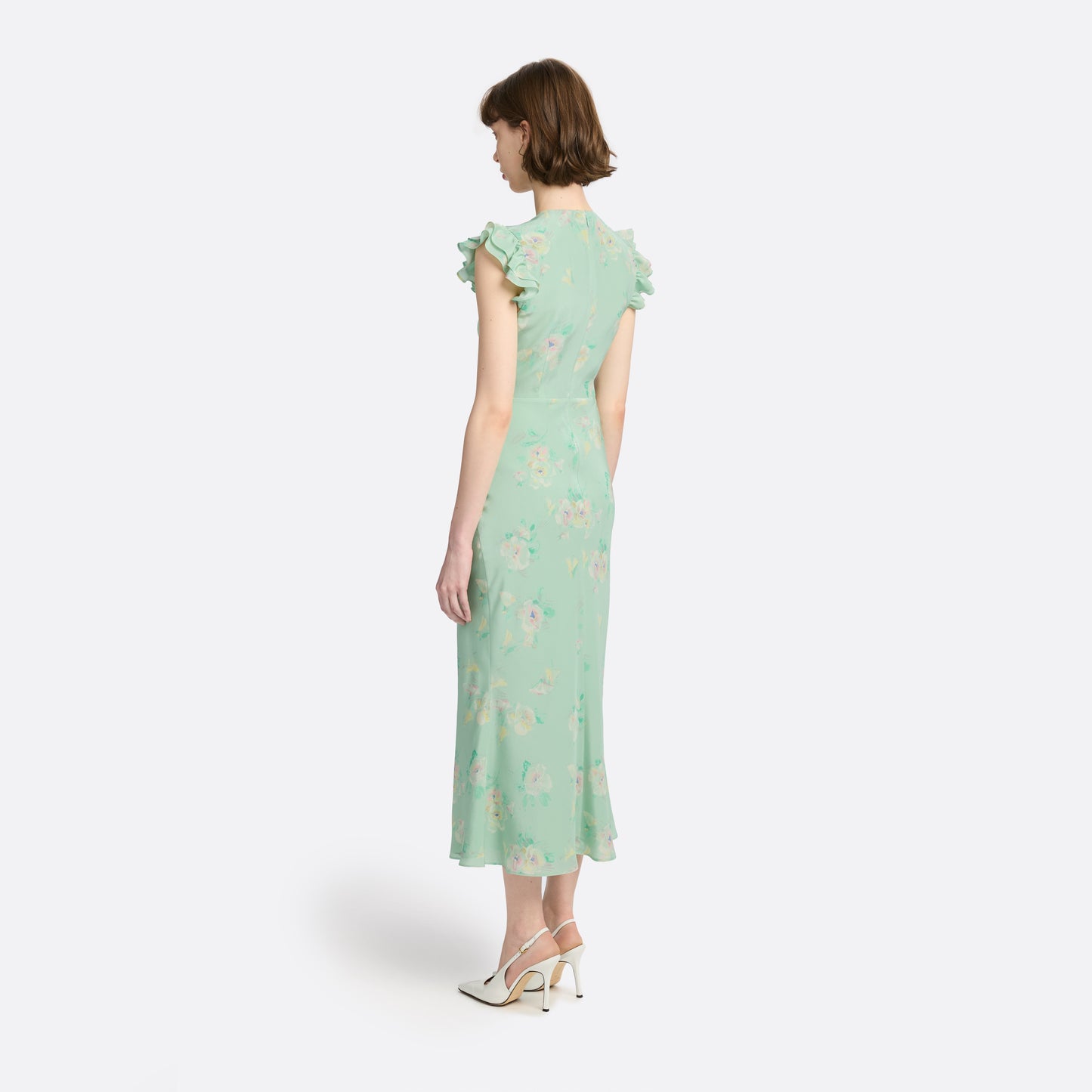 Light green floral print silk crêpe de chine sleeveless midi dress with bows, featuring keyhole cut-out and ruffled details.