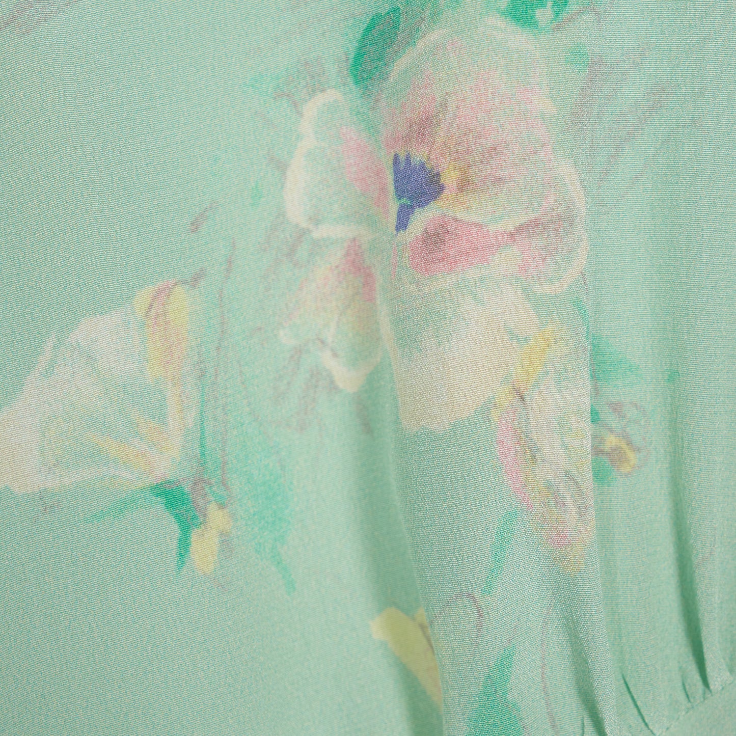 Light green floral print silk crêpe de chine sleeveless midi dress with bows, featuring keyhole cut-out and ruffled details.