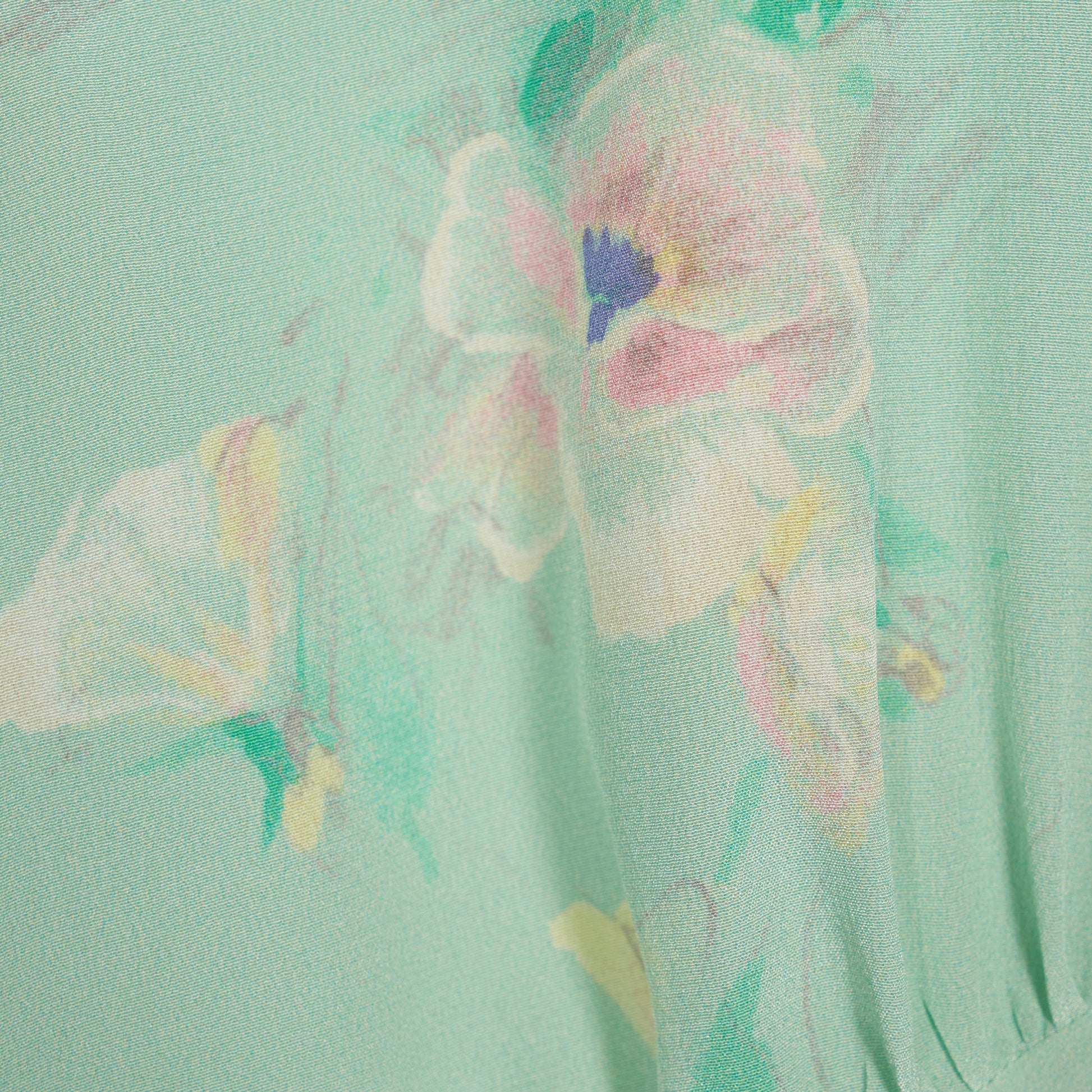 Light green floral print silk crêpe de chine sleeveless midi dress with bows, featuring keyhole cut-out and ruffled details.