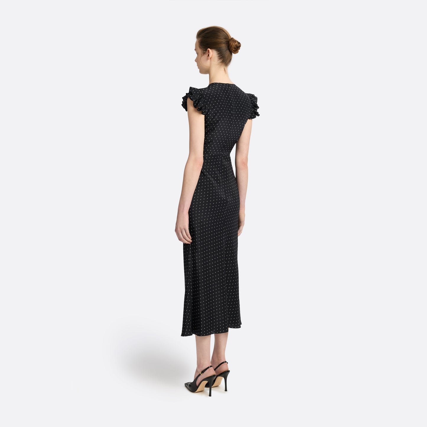 Ivory diamond print on black silk crêpe de chine sleeveless midi dress with bows, featuring keyhole cut-out and ruffled details.