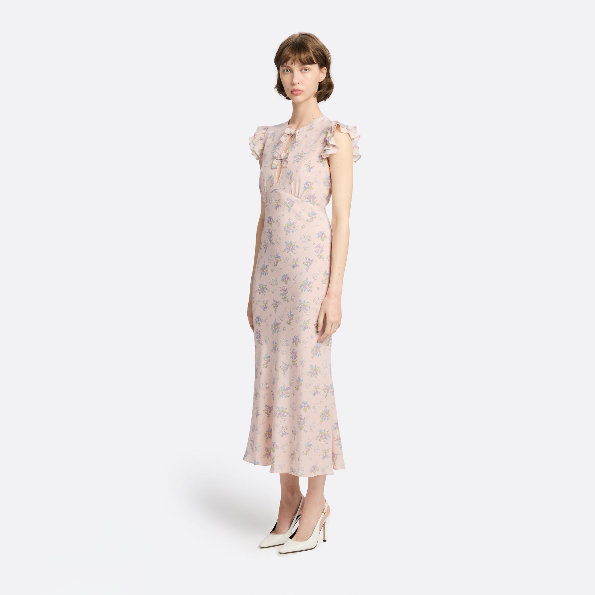 Light rose floral print silk crêpe de chine sleeveless midi dress with bows, featuring keyhole cut-out and ruffled details.