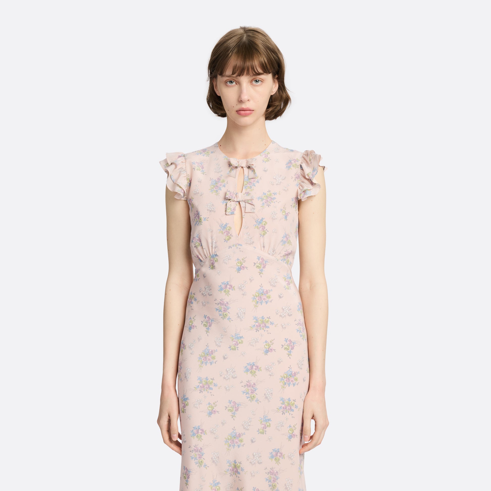 Light rose floral print silk crêpe de chine sleeveless midi dress with bows, featuring keyhole cut-out and ruffled details.
