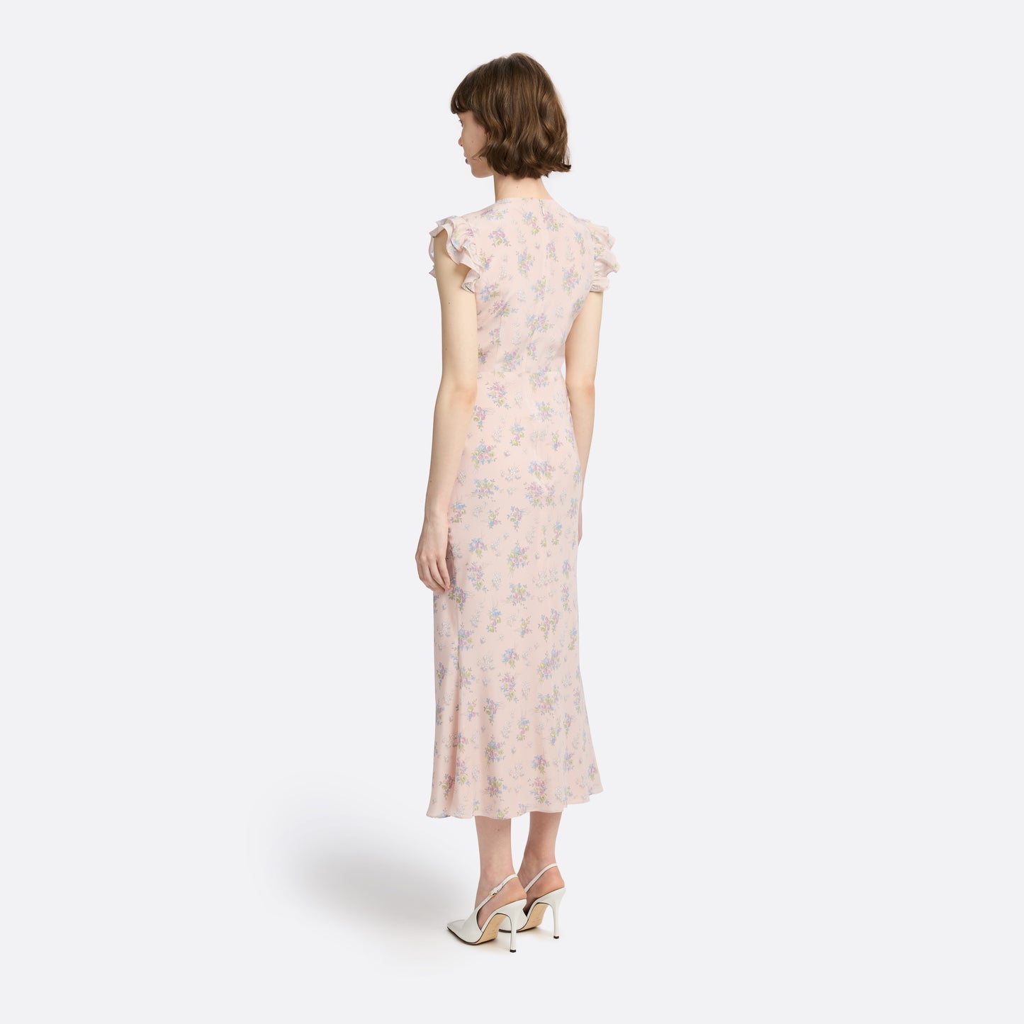 Light rose floral print silk crêpe de chine sleeveless midi dress with bows, featuring keyhole cut-out and ruffled details.
