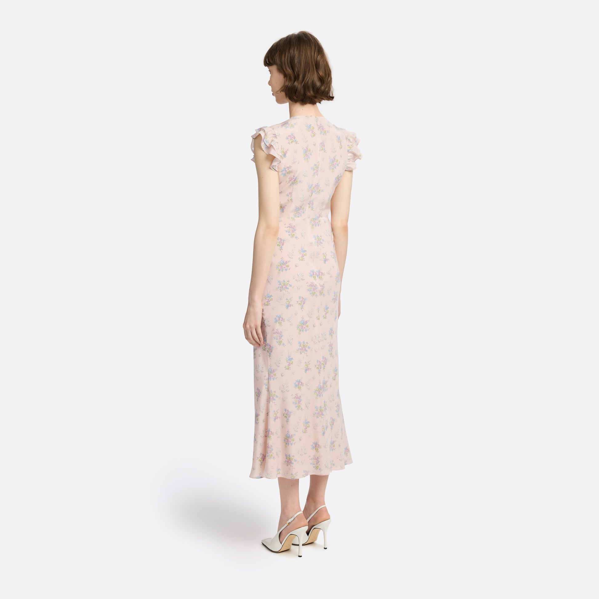 Light rose floral print silk crêpe de chine sleeveless midi dress with bows, featuring keyhole cut-out and ruffled details.