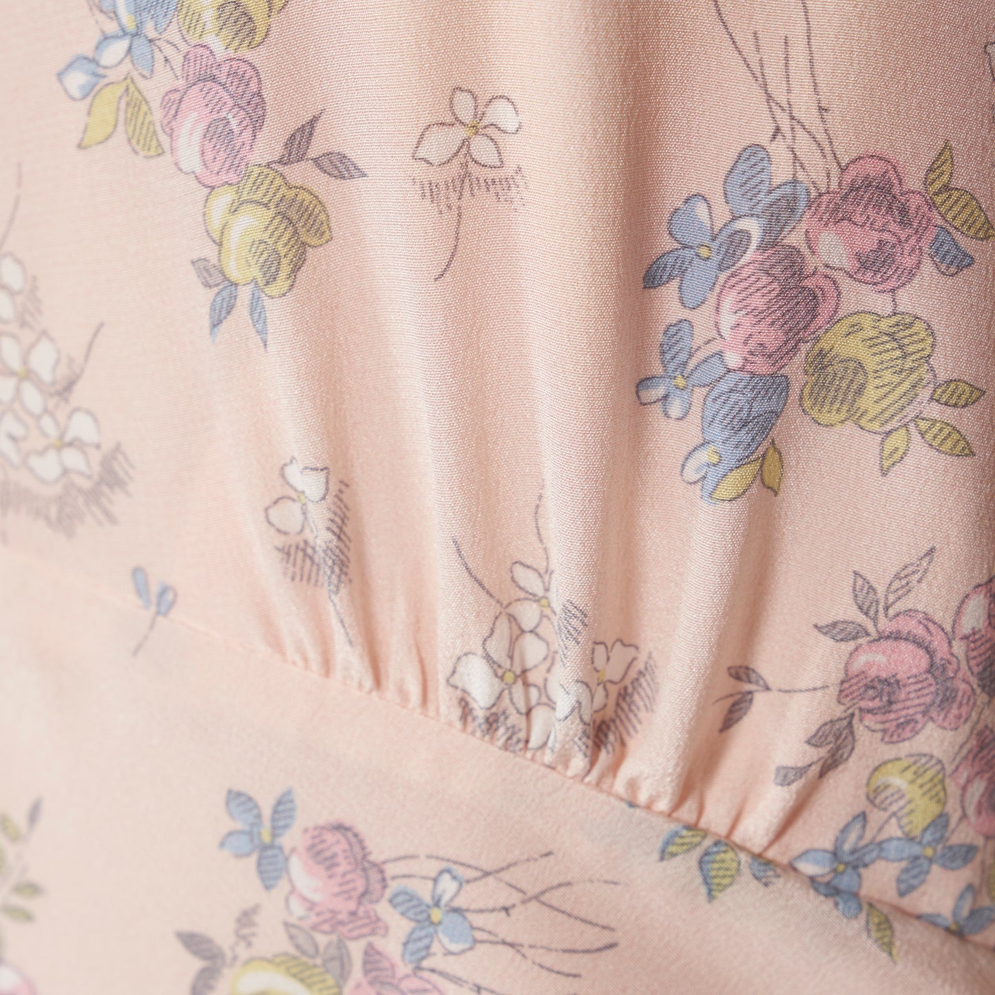 Light rose floral print silk crêpe de chine sleeveless midi dress with bows, featuring keyhole cut-out and ruffled details.