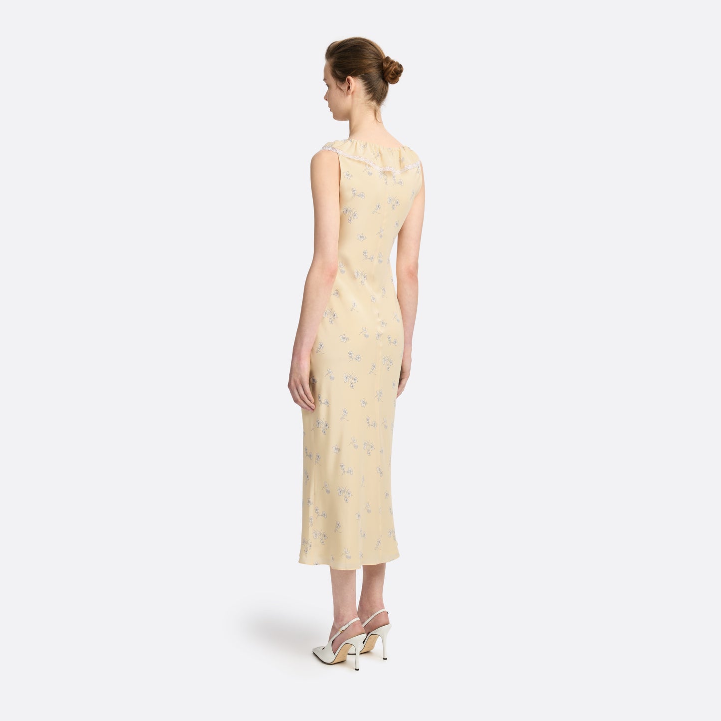Pale yellow floral print silk crêpe de chine slip midi dress with a scoop neckline, featuring ruffles, lace trim, and a bow.