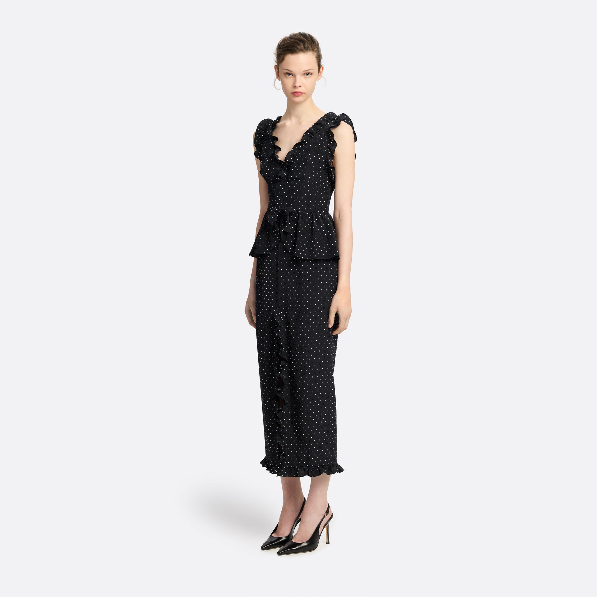 Ivory diamond print on black silk crêpe de chine midi dress with a deep V neckline and ruffled trims, featuring a peplum waist, front split and bow.
