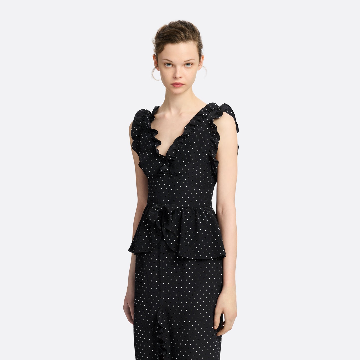 Ivory diamond print on black silk crêpe de chine midi dress with a deep V neckline and ruffled trims, featuring a peplum waist, front split and bow.