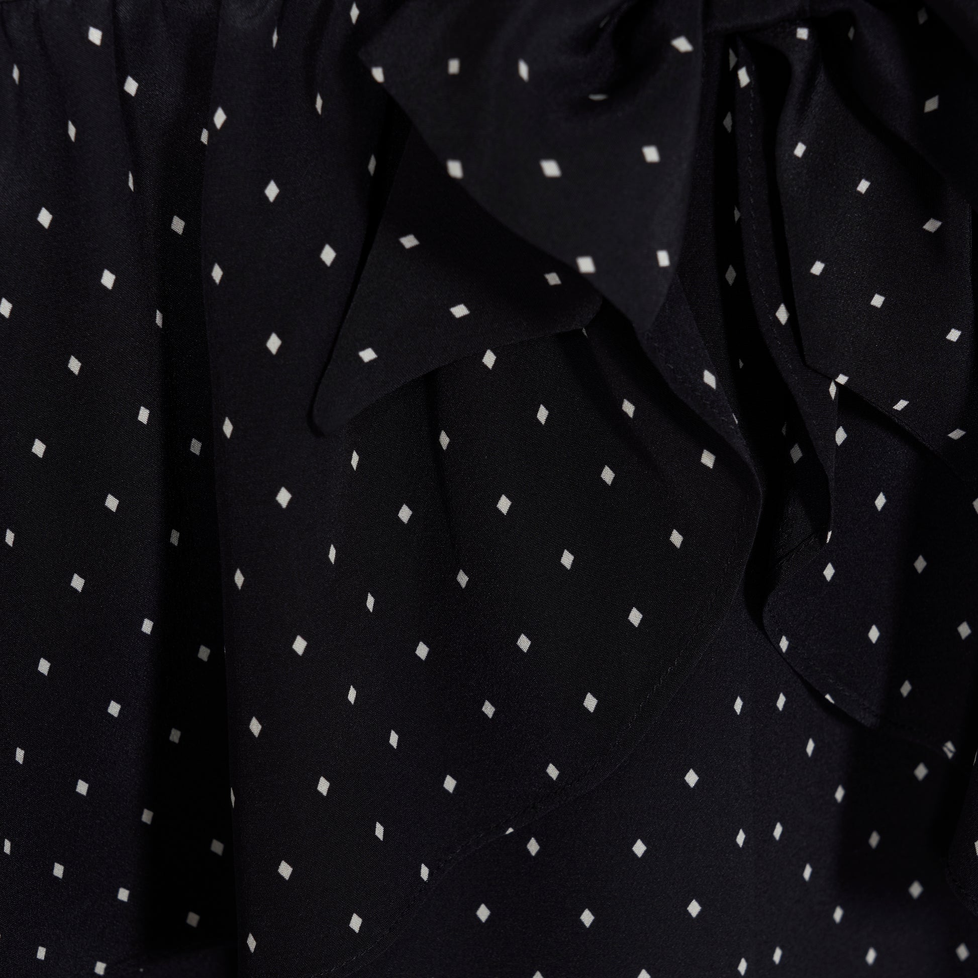Ivory diamond print on black silk crêpe de chine midi dress with a deep V neckline and ruffled trims, featuring a peplum waist, front split and bow.