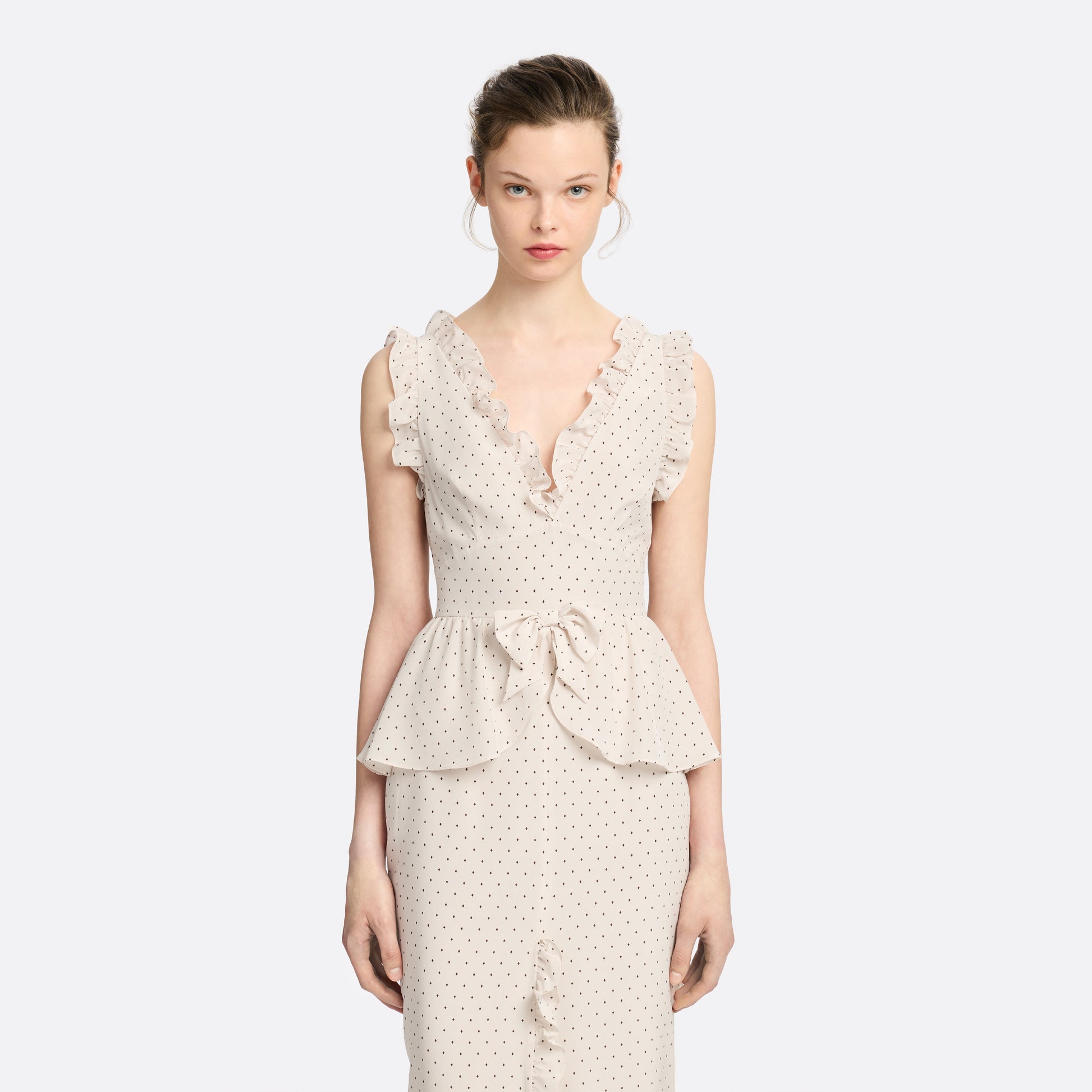 Brown diamond print on almond silk crêpe de chine midi dress with a deep V neckline and ruffled trims, featuring a peplum waist, front split and bow.
