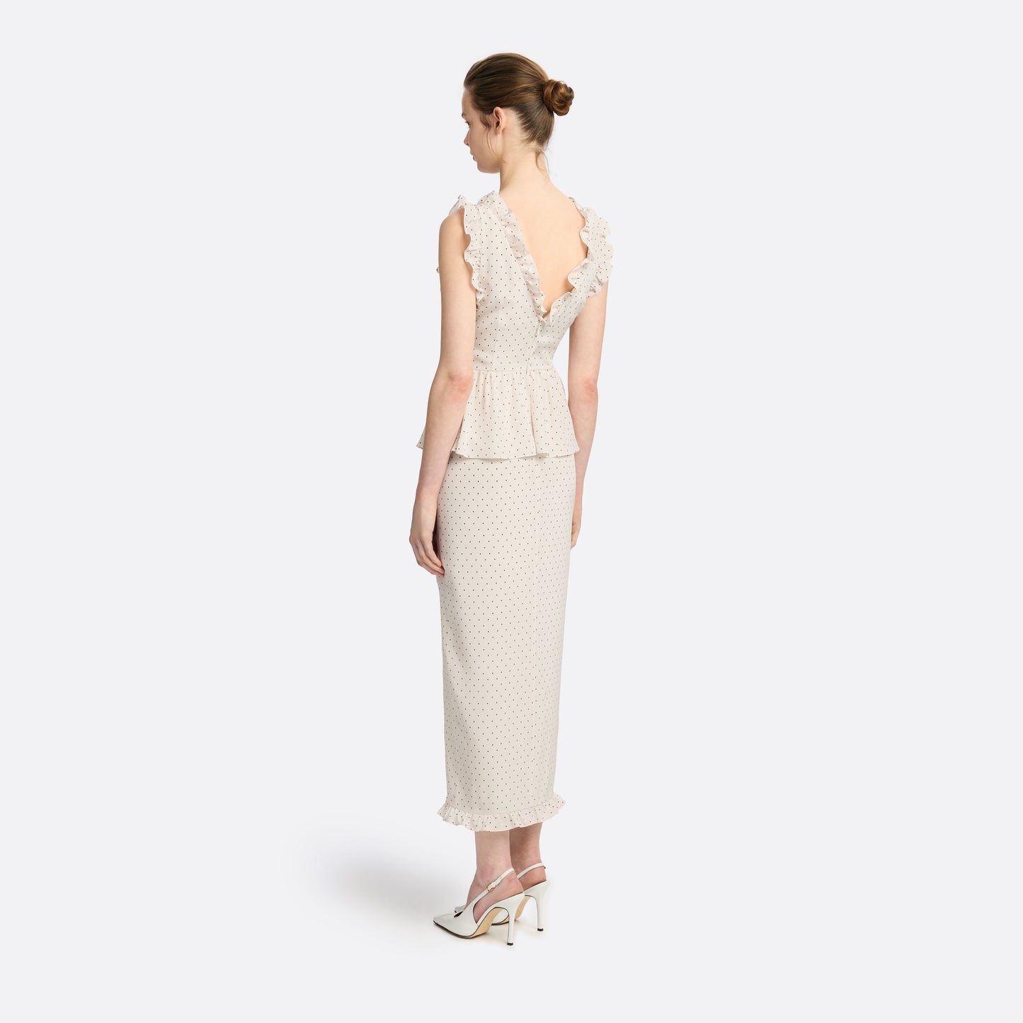 Brown diamond print on almond silk crêpe de chine midi dress with a deep V neckline and ruffled trims, featuring a peplum waist, front split and bow.