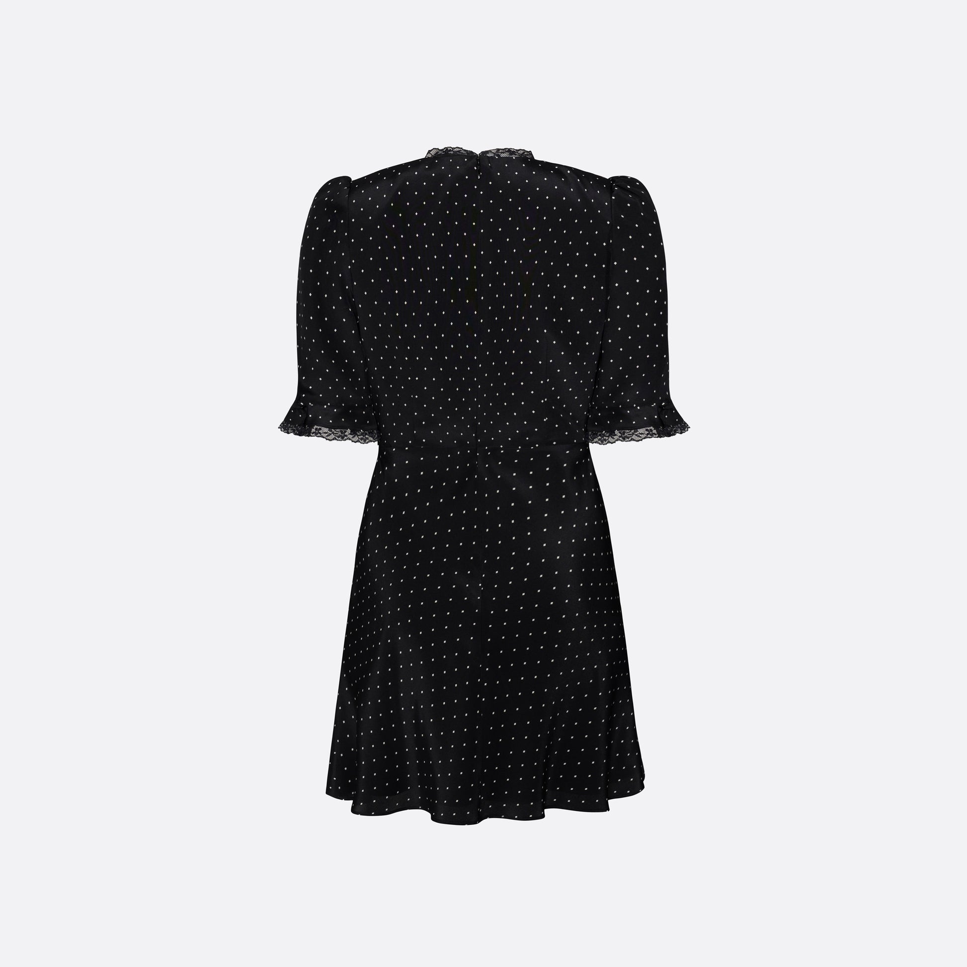 Ivory diamond print on black silk crêpe de chine mini dress with a V neckline and short sleeves, featuring lace trims and a bow.