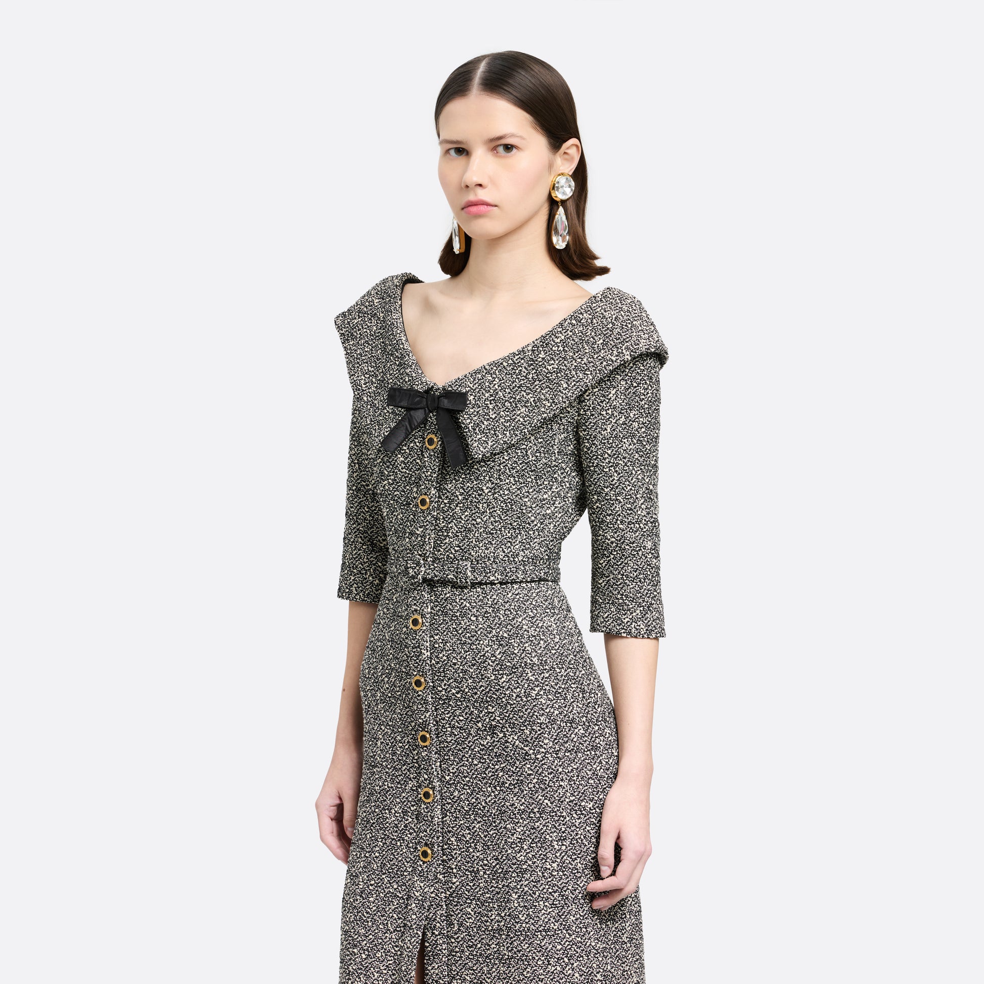 Black and white melange sequins tweed midi dress cut to a fitted silhouette with black and gold-tone buttons and a slim belt.

Look 12 – Fall Winter 2026 Lookbook.