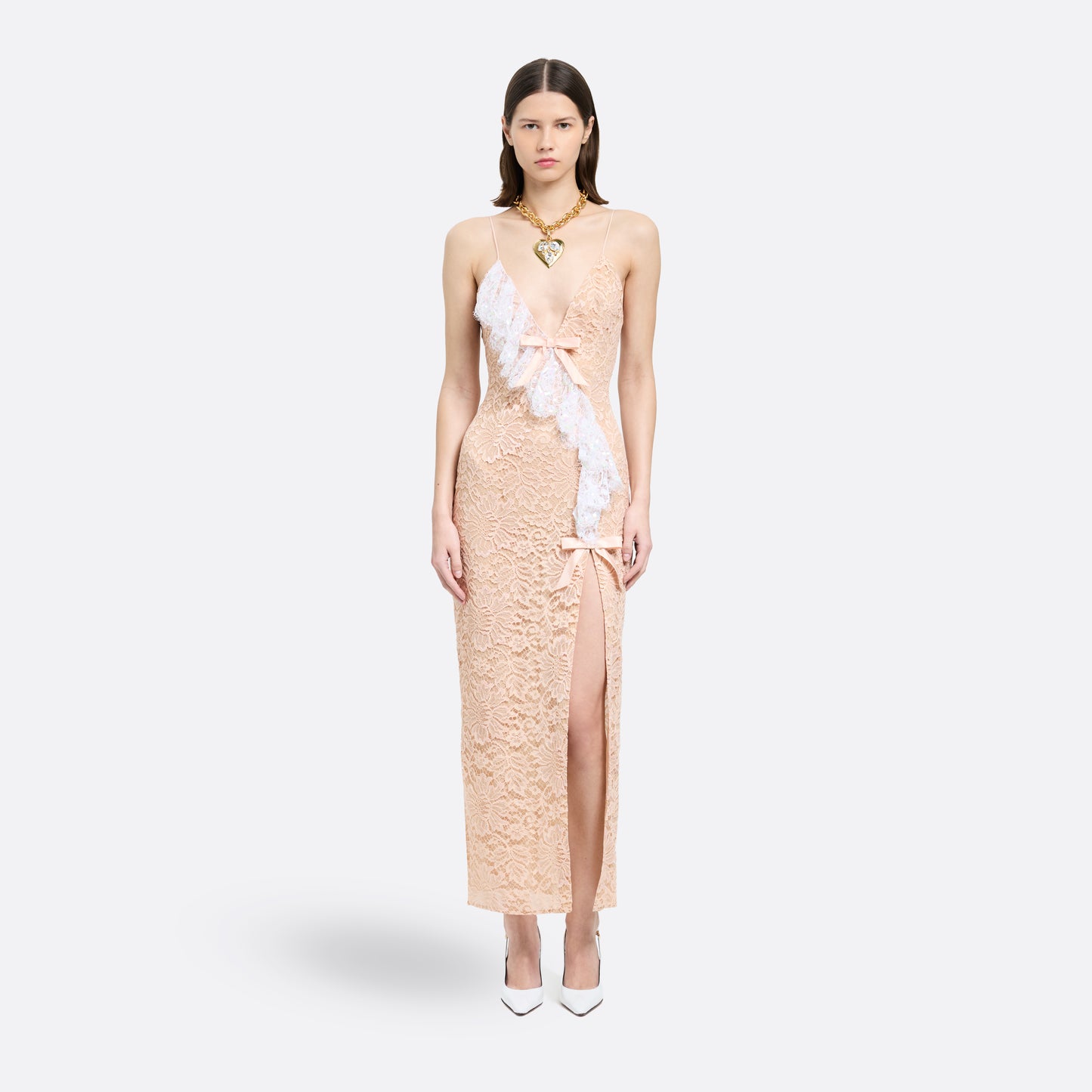Nude lace slip dress cut to a fitted silhouette with delicate spaghetti straps and a V-neckline detailed with a sequin-embroidered lace volant. Finished with silk satin bows and a front split.

Look 33 – Fall Winter 2026 Lookbook