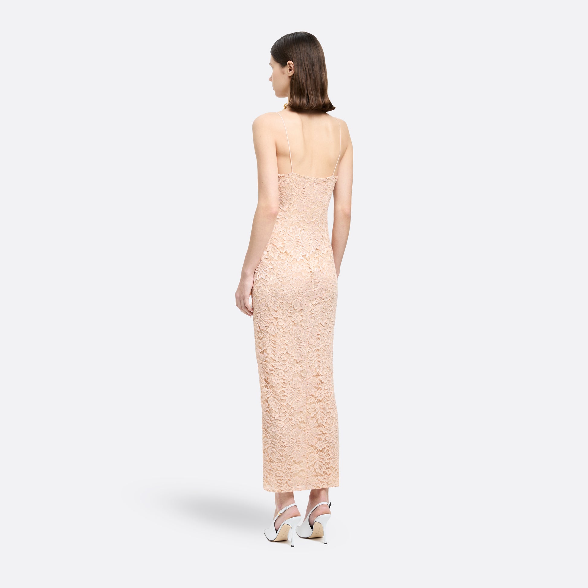 Nude lace slip dress cut to a fitted silhouette with delicate spaghetti straps and a V-neckline detailed with a sequin-embroidered lace volant. Finished with silk satin bows and a front split.

Look 33 – Fall Winter 2026 Lookbook