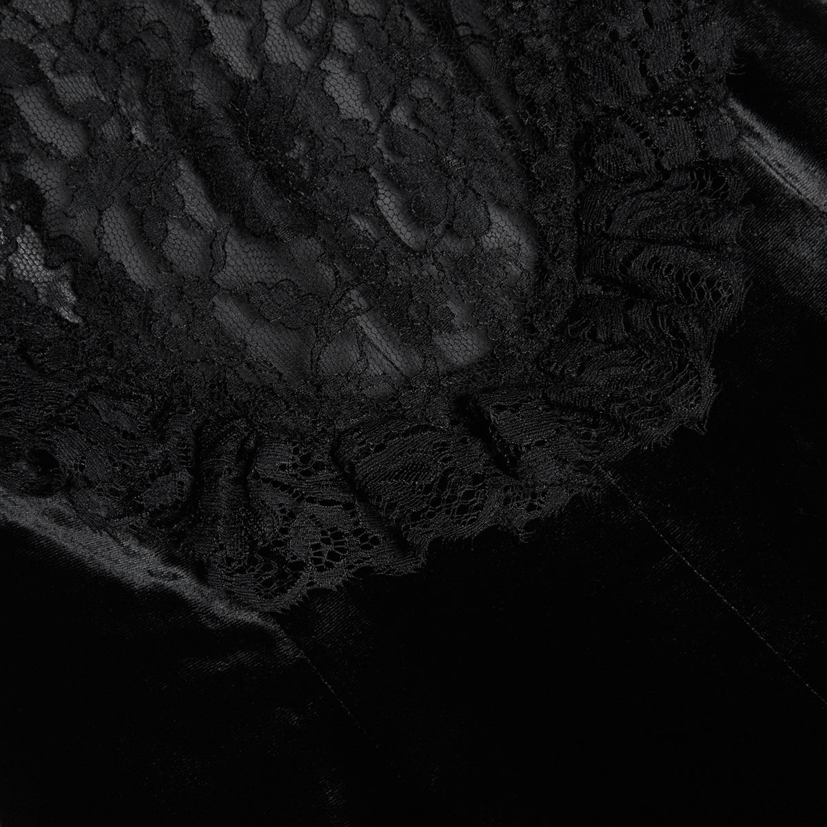 Black silk velvet evening dress featuring an open back and black lace inlay with ruffle trims.

Look 25 – Spring Summer 2027 Lookbook